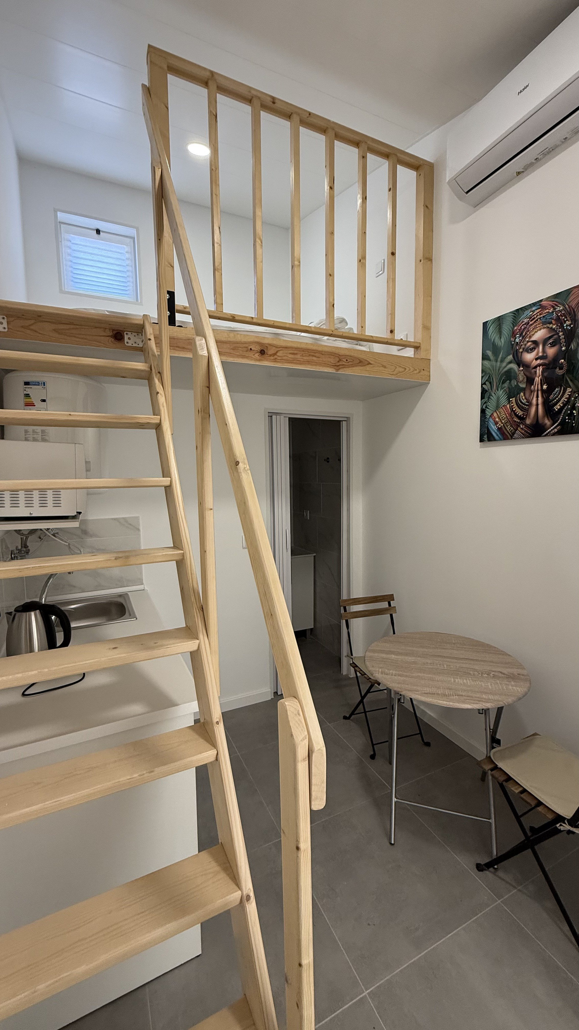 Loft studio with staircase and dining area
