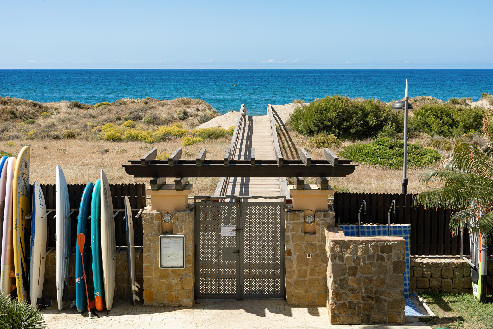 Beach access gate with surfboards