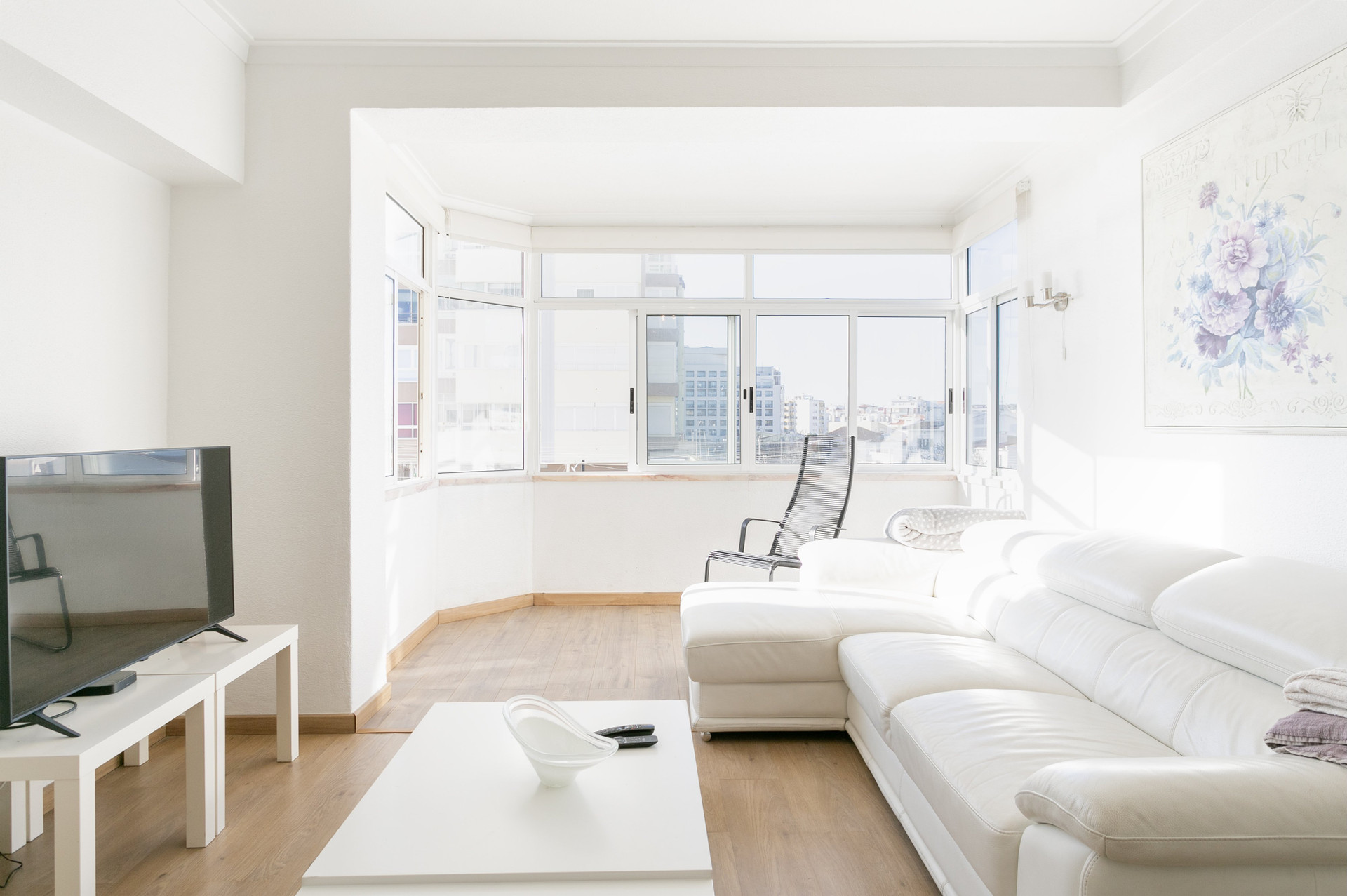 Bright living room with sofa and TV
