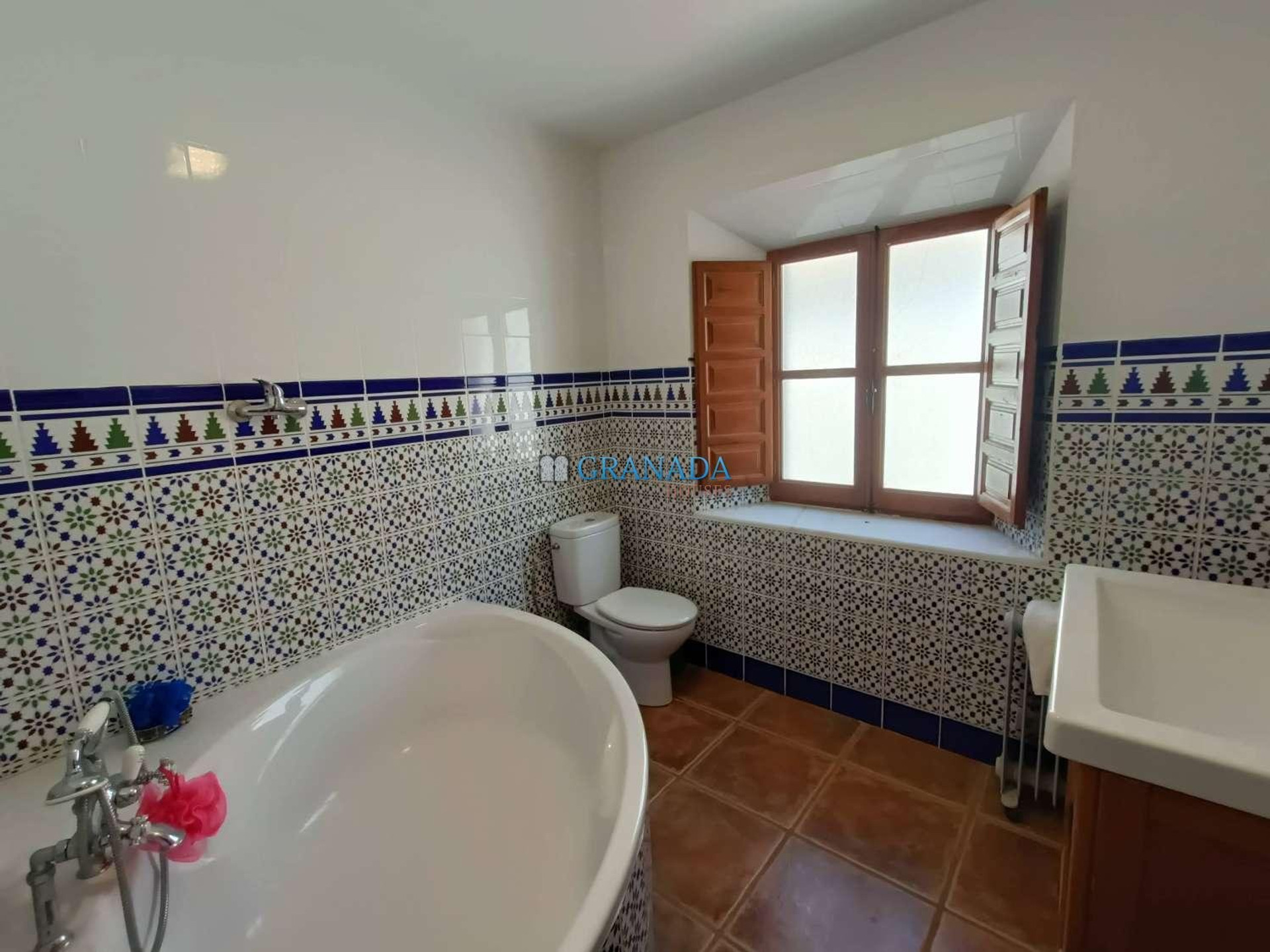 Bathroom with tiled walls and tub