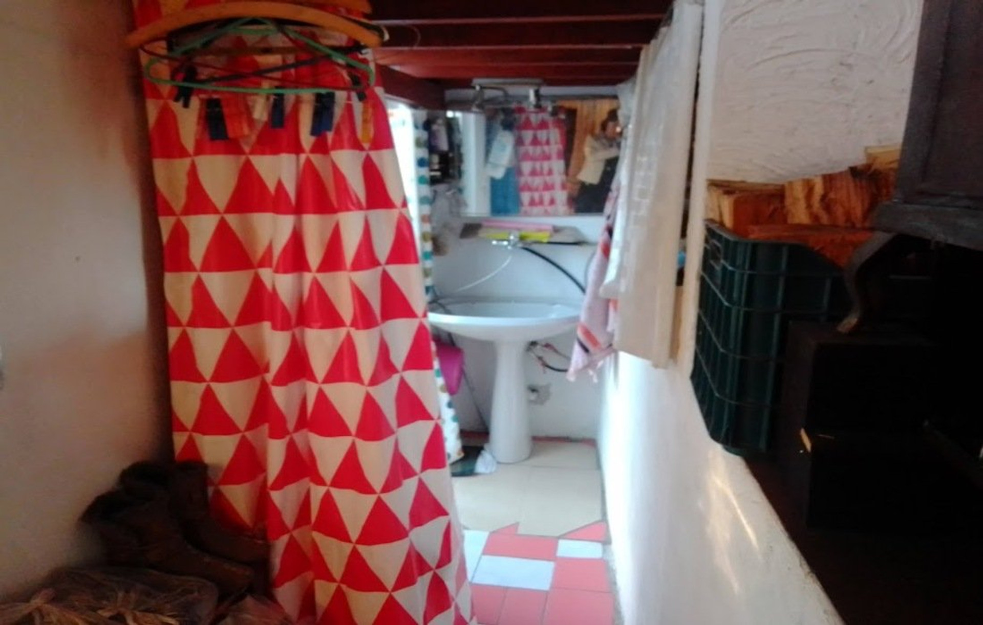 Bathroom with red patterned curtain