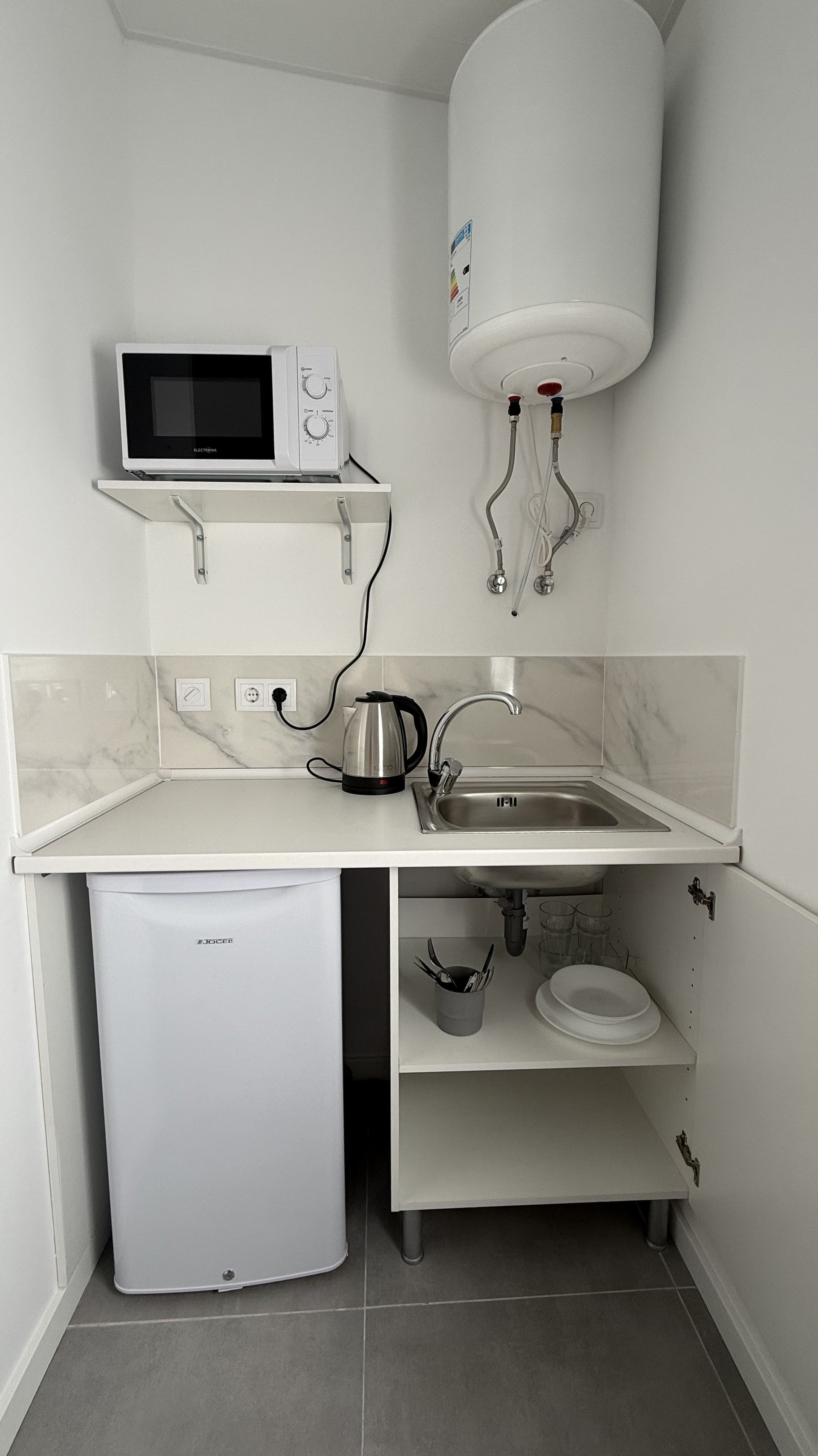 Kitchenette with dishware and utensils