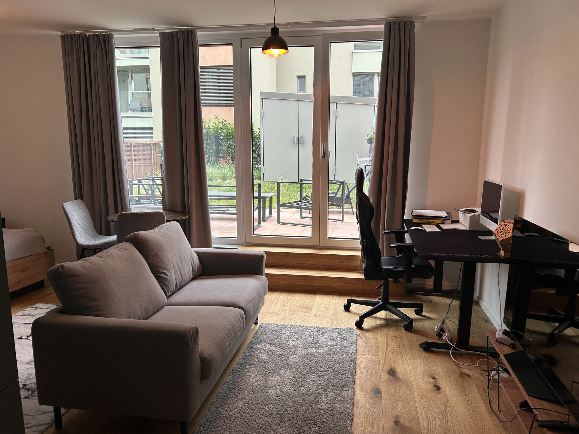 Living room with desk and terrace view