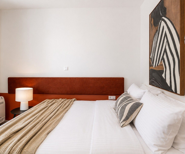 Bedroom with striped artwork