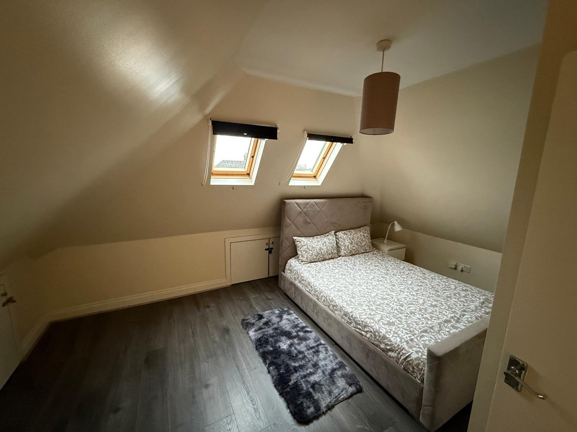 Double bedroom with skylights pendant light