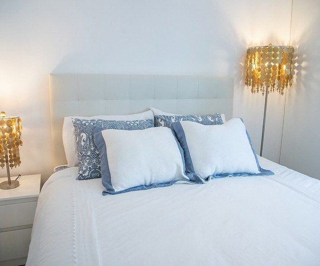 Bed with gold accent lamps