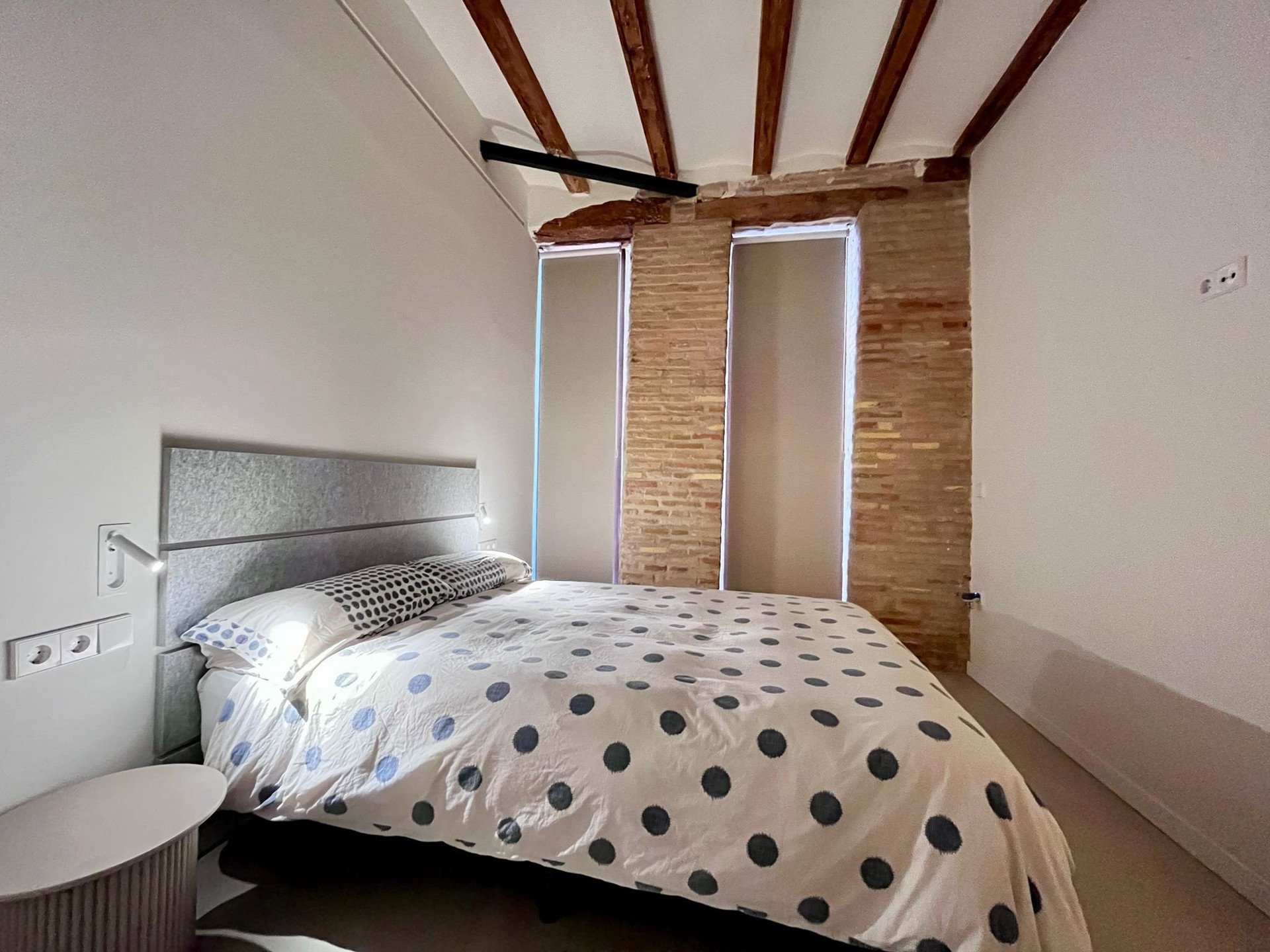 Double bedroom with exposed brick