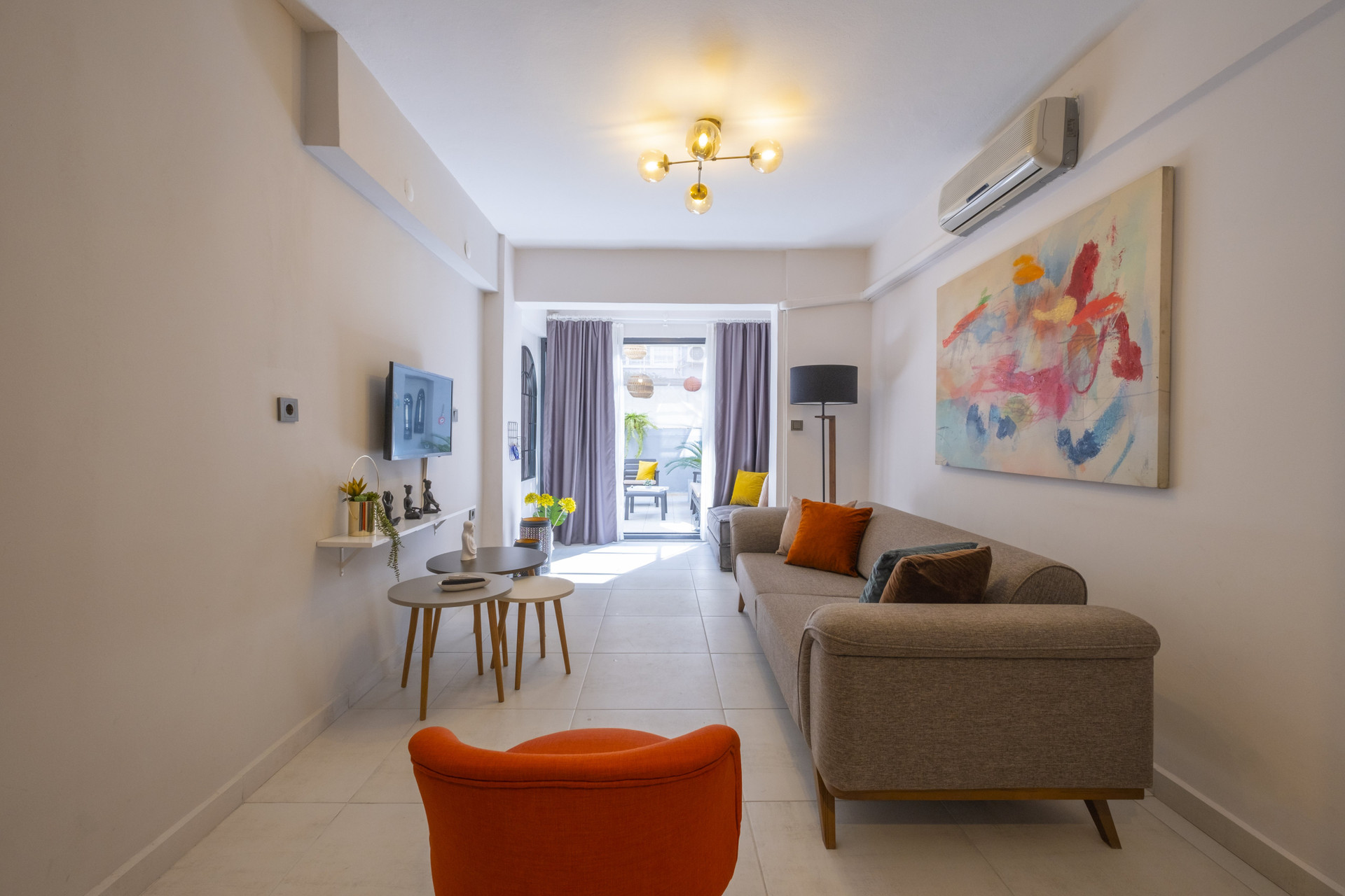 Living room with orange armchair