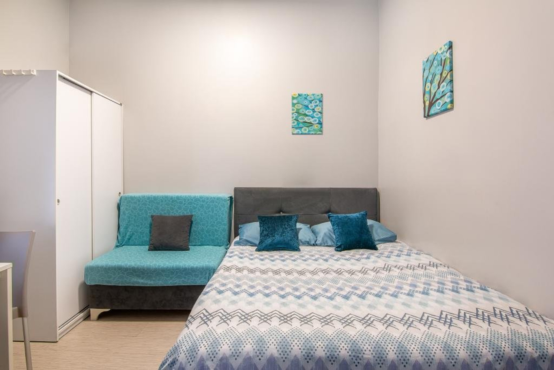 Double bed with sofa and wardrobe
