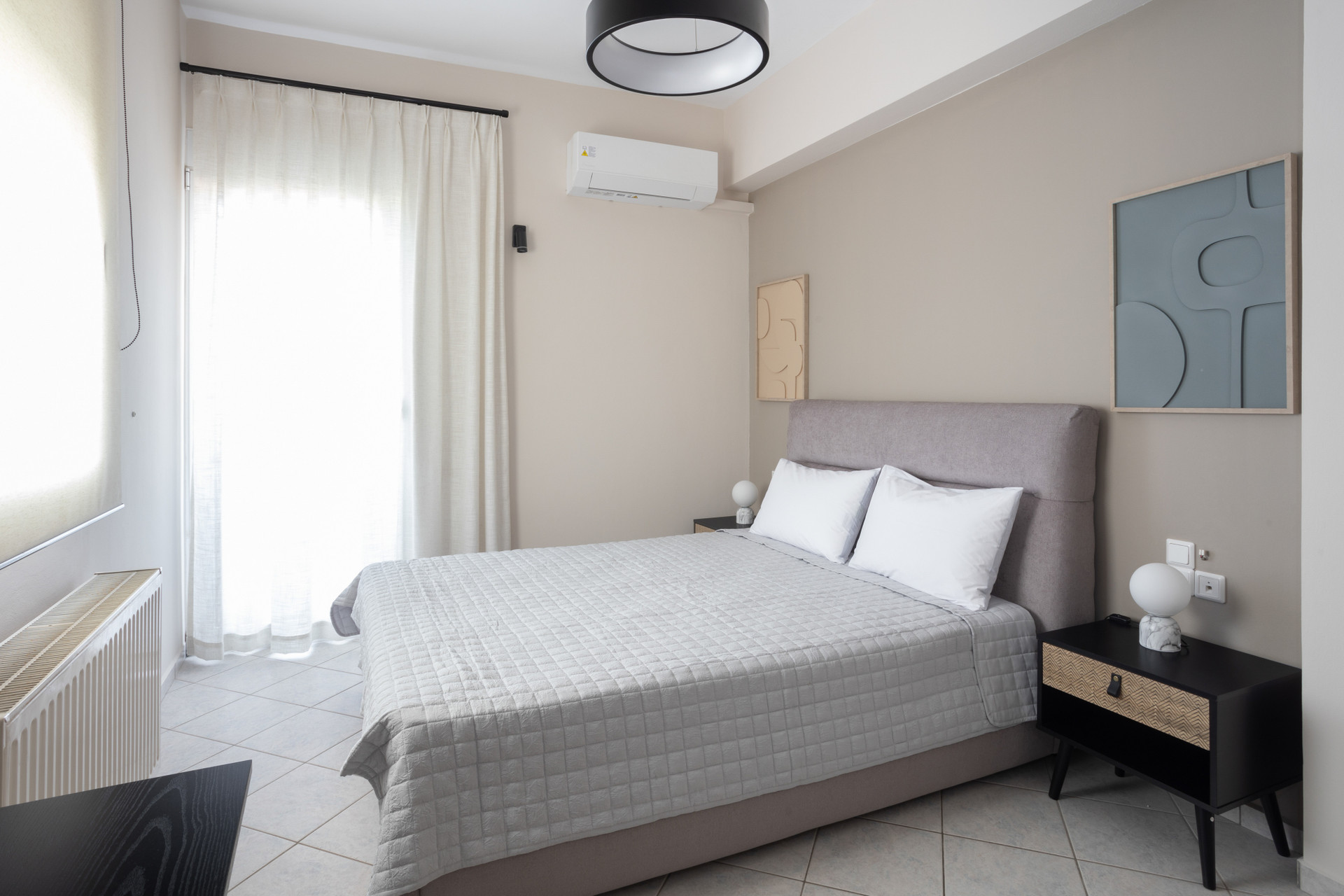 Well-appointed bedroom with double bed, bedside storage, and excellent natural lighting