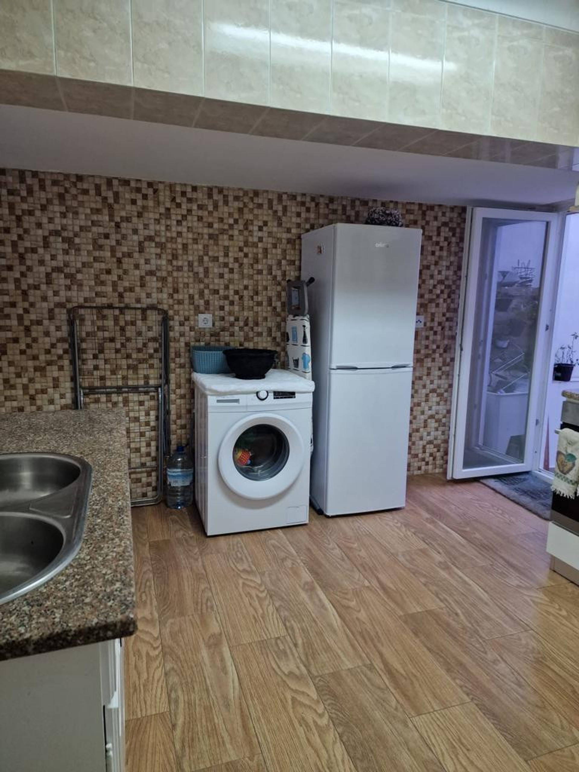 Kitchen with washer and fridge