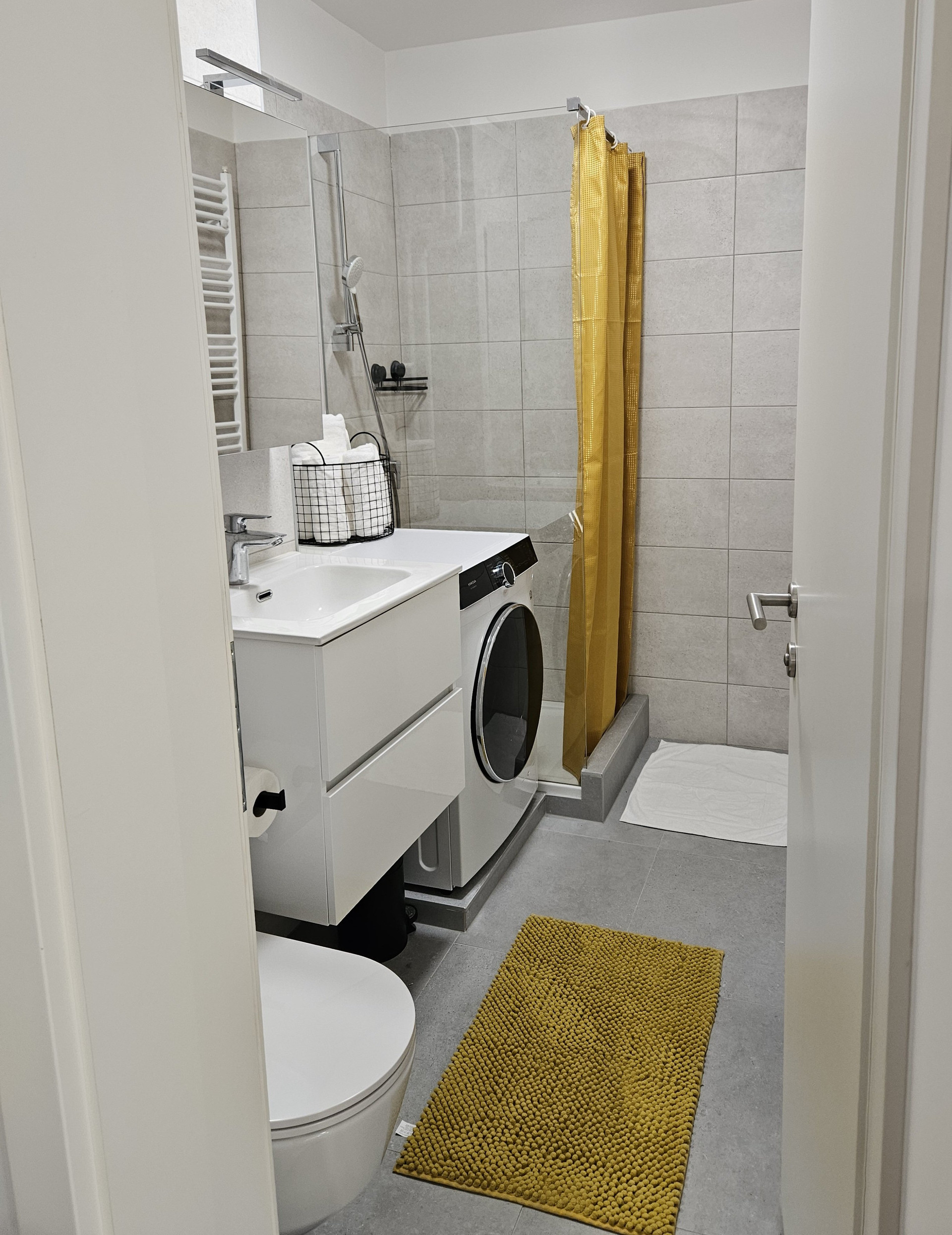 Bathroom with shower and washing machine