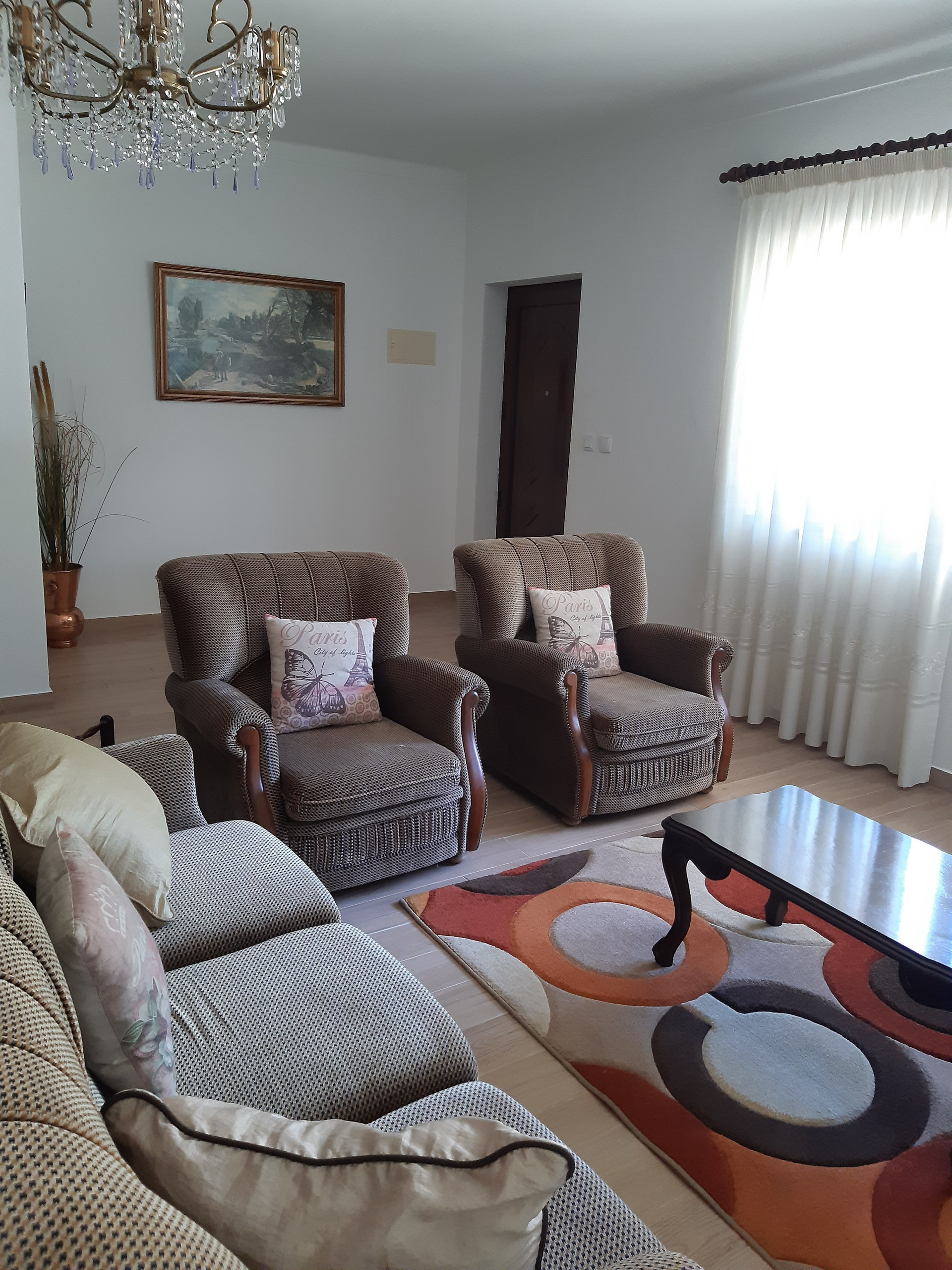 Living room with armchairs and chandelier