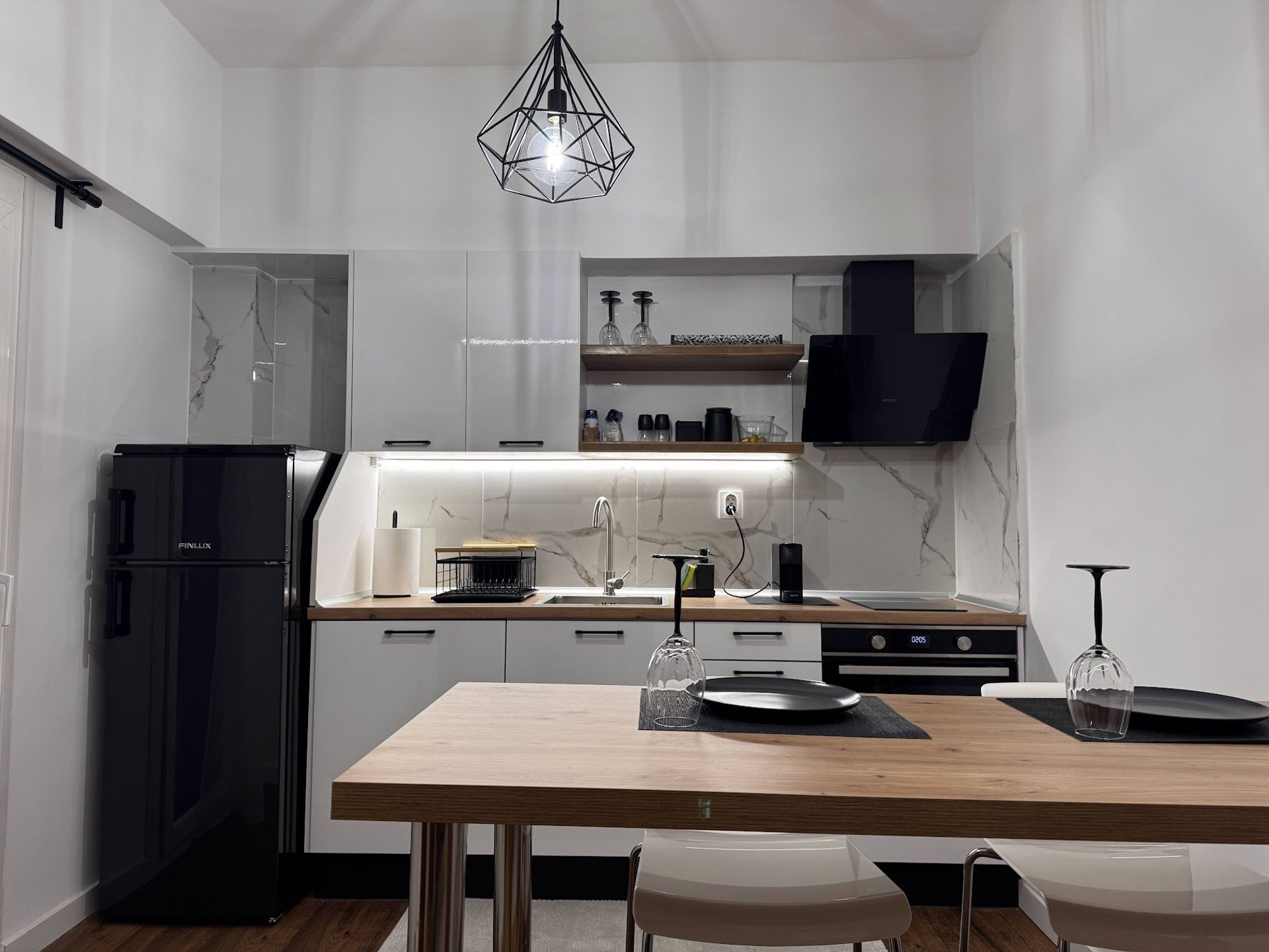 Modern white kitchen with dining table