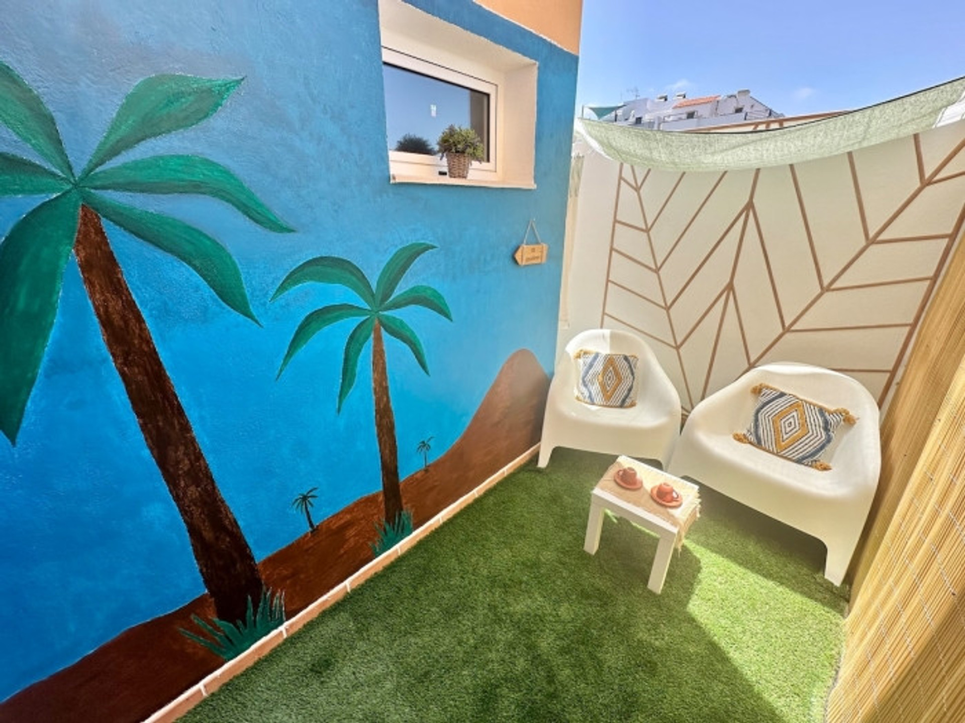 Colorful terrace with palm mural