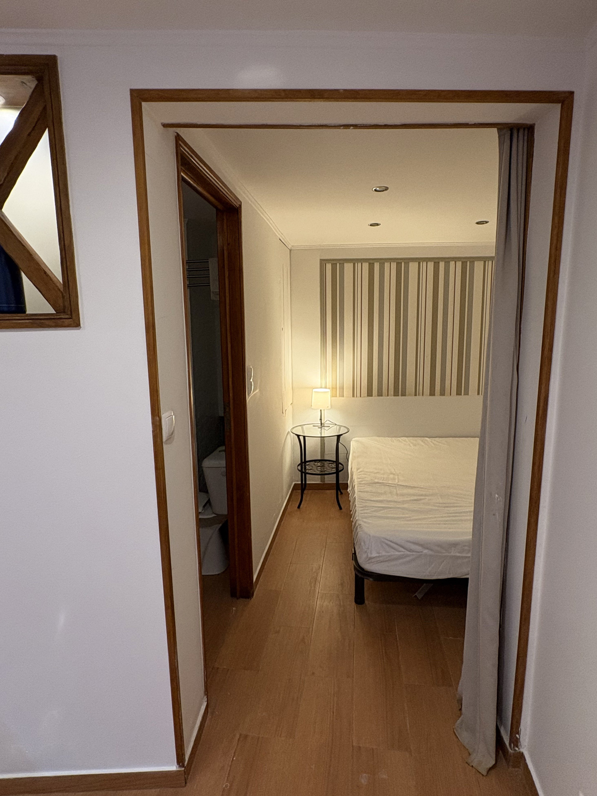 Hallway view into bedroom and bathroom