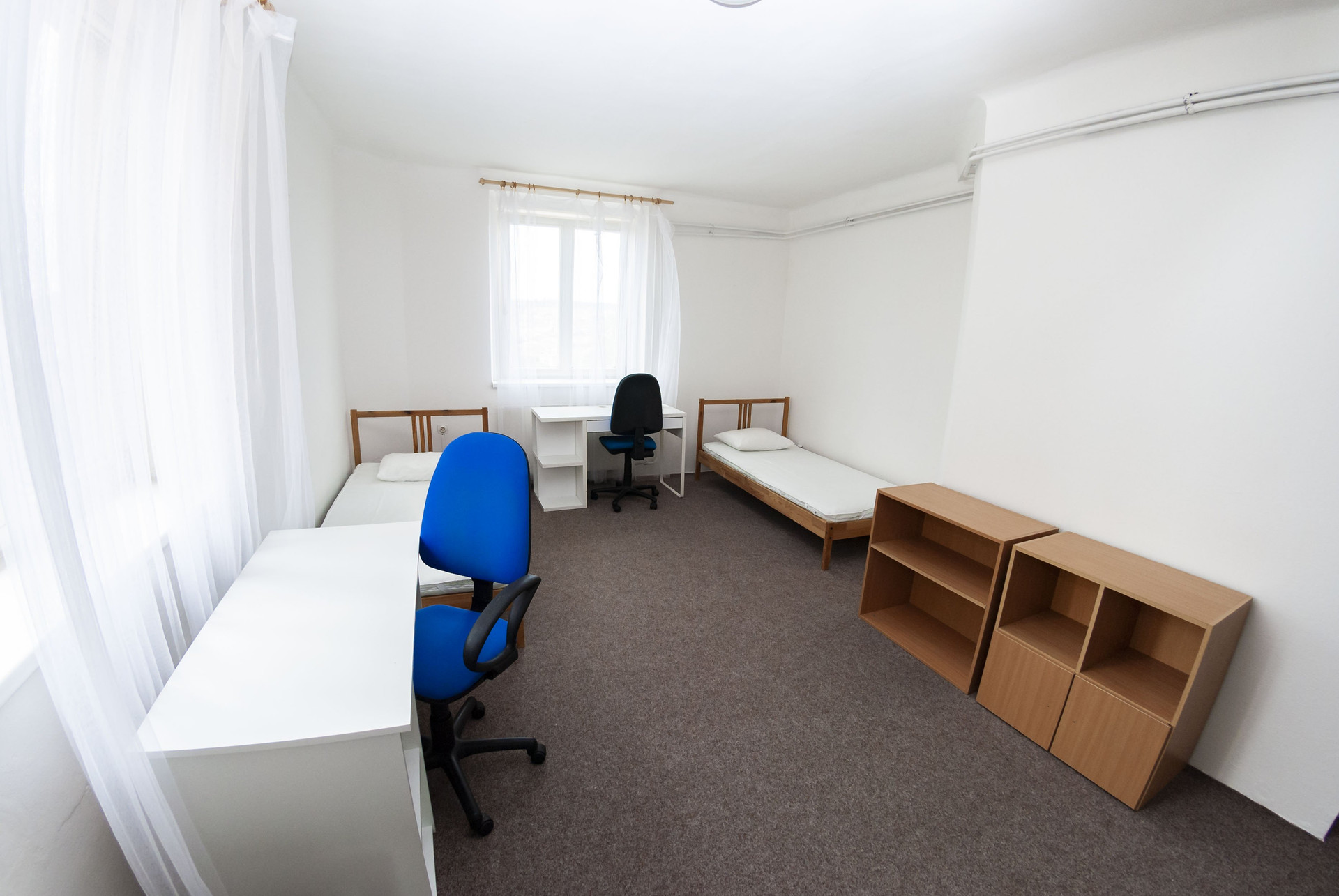 Twin bedroom with desks and shelves