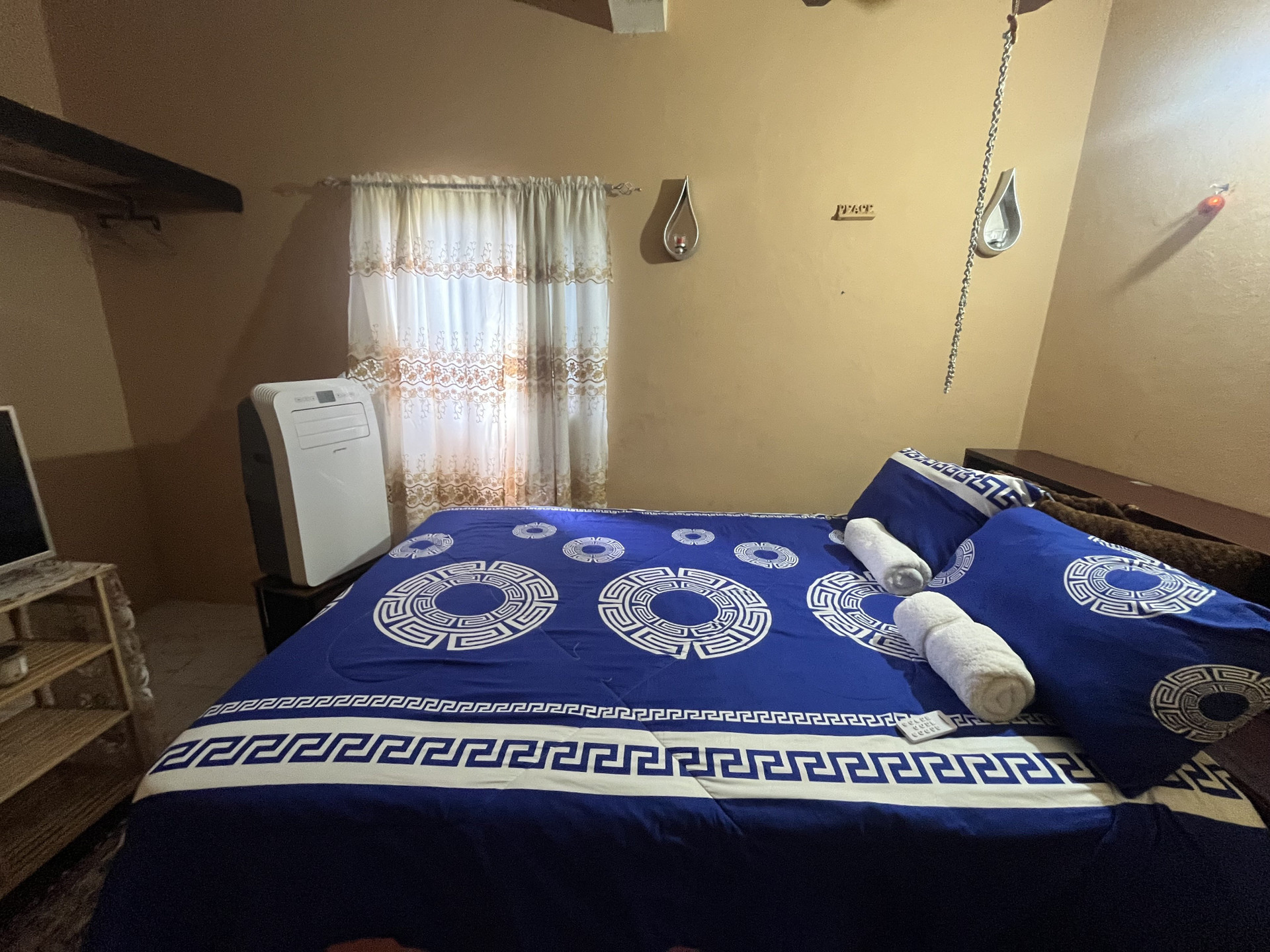 Bedroom with blue patterned bedspread