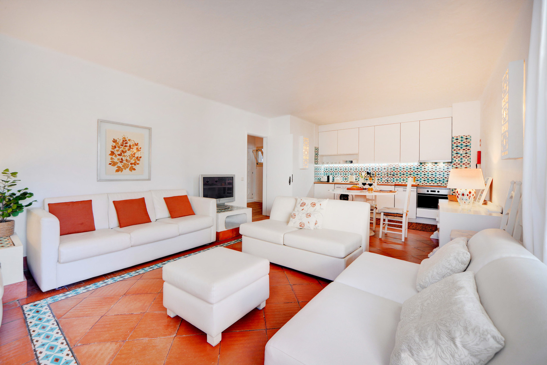 Living room with a sofa bed, wood-burning fireplace, and TV.