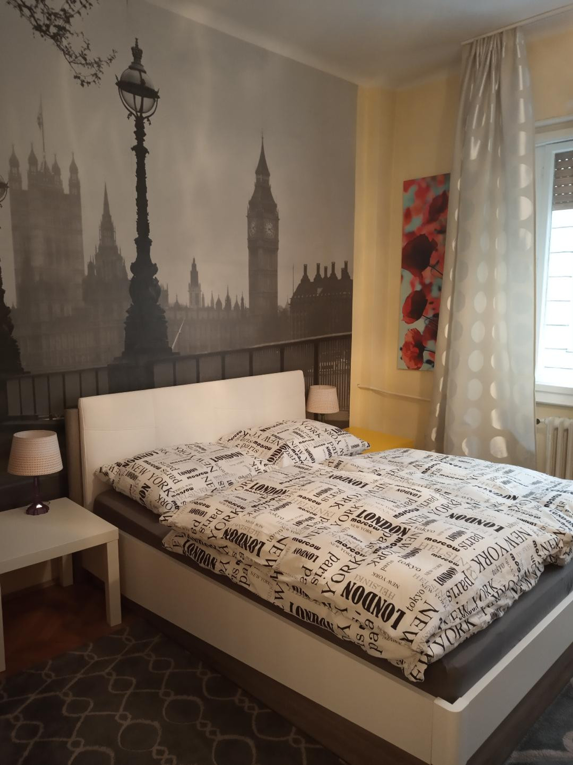 spacious bedroom with large window wich face the street