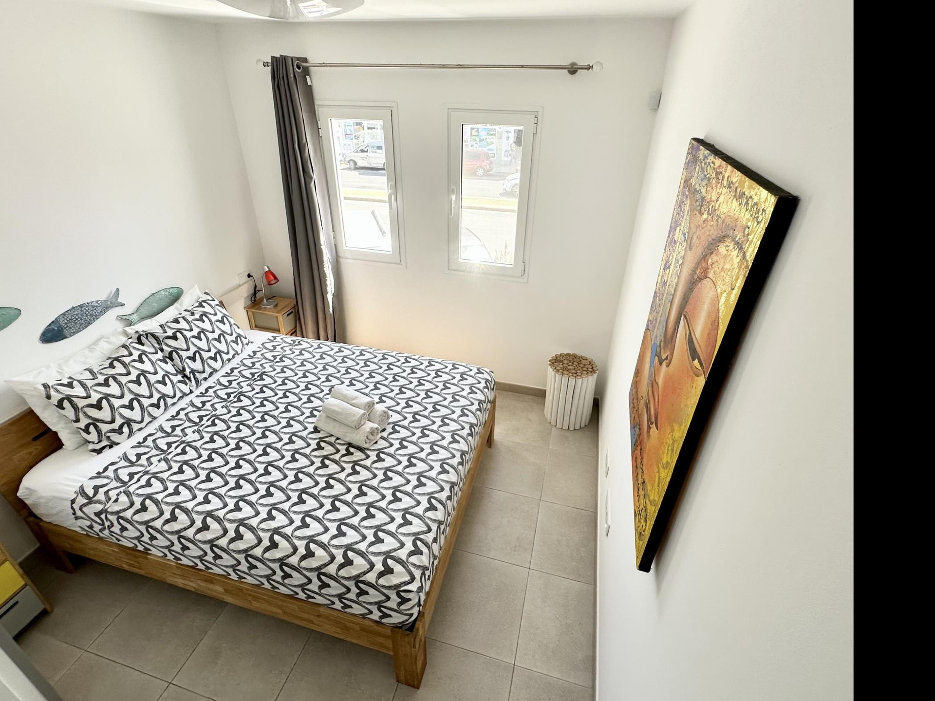 Bedroom with artwork and windows