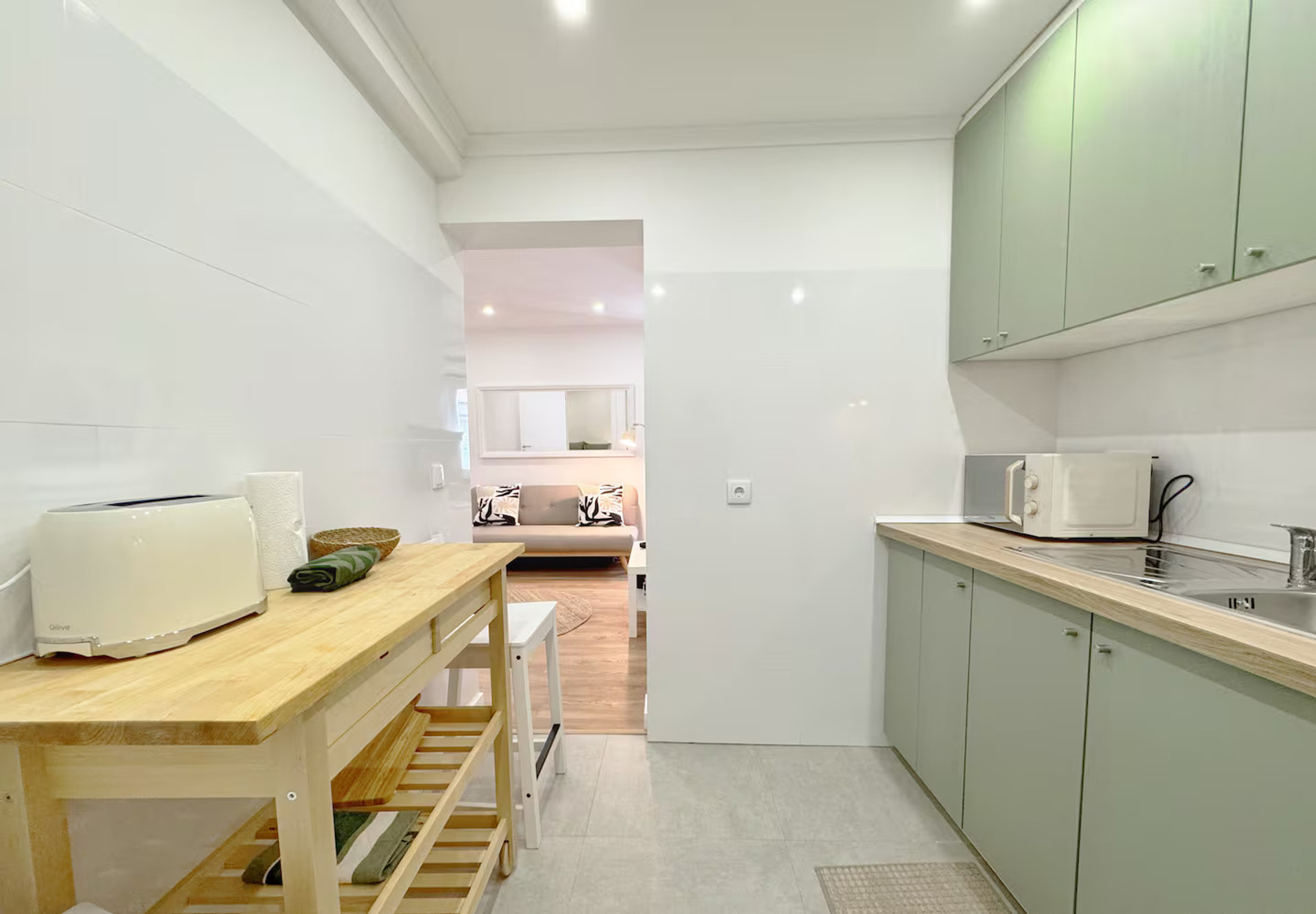 Green kitchen open to living