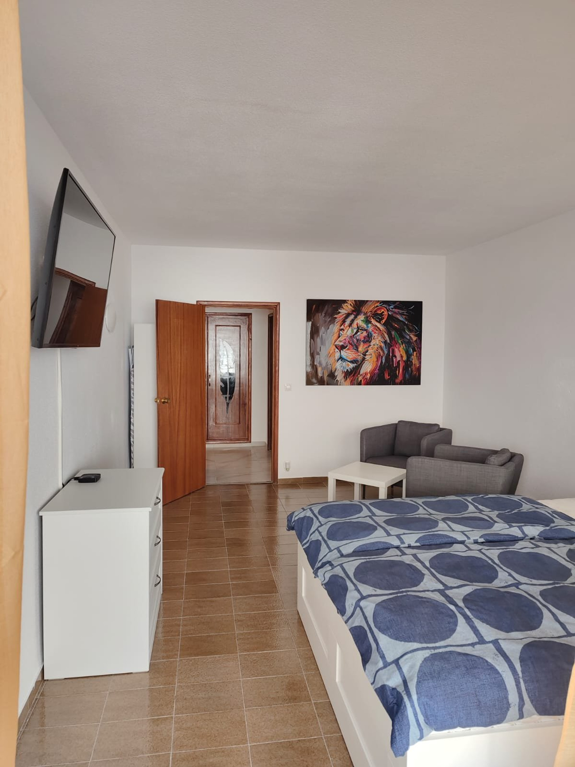 Bedroom with TV and seating