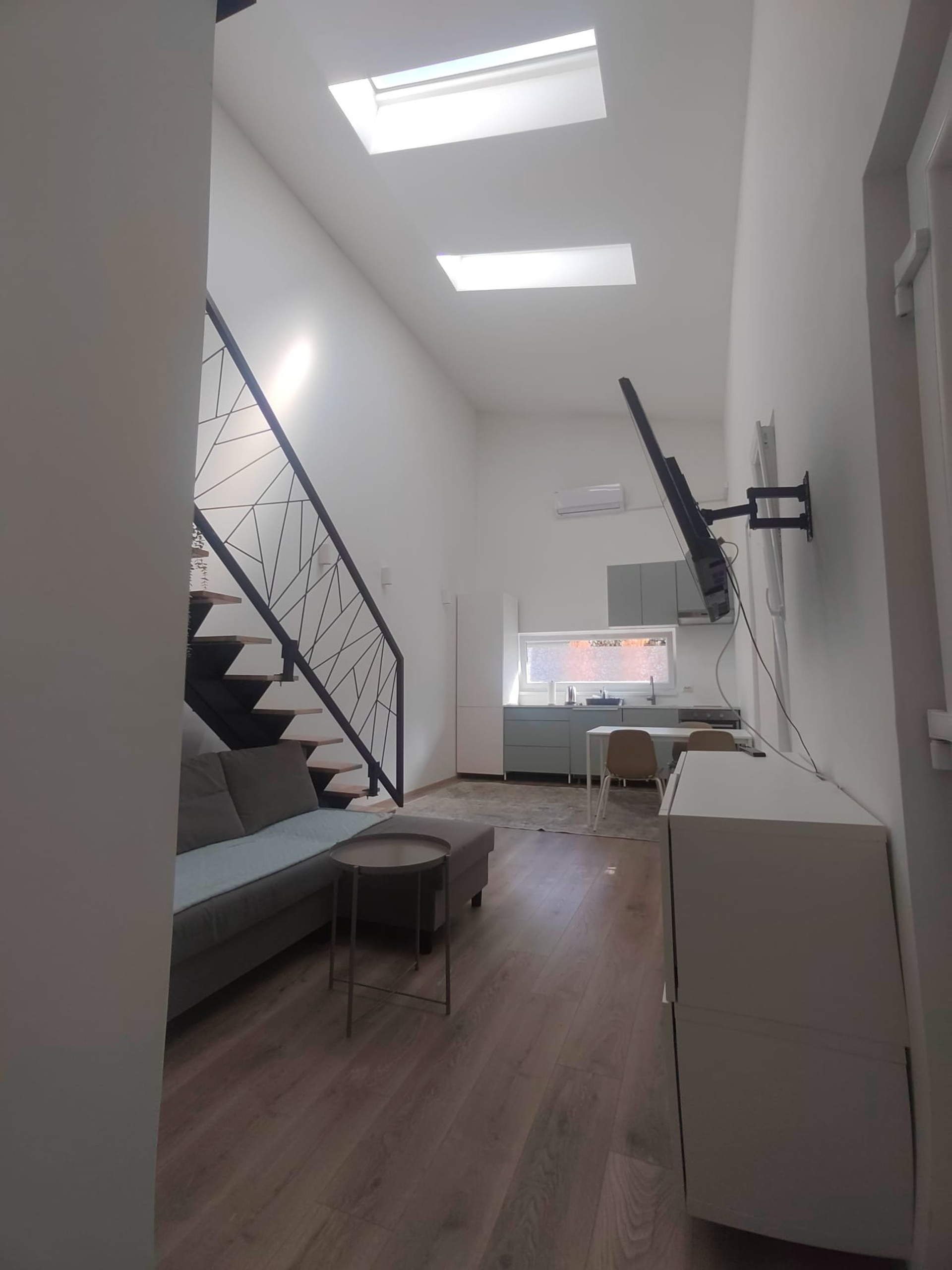 Open living area with loft stairs