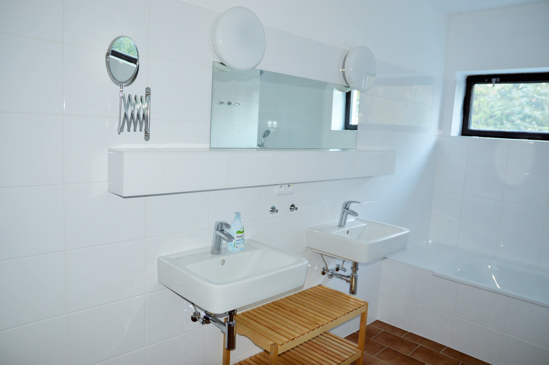 Bathroom with double sinks and tub