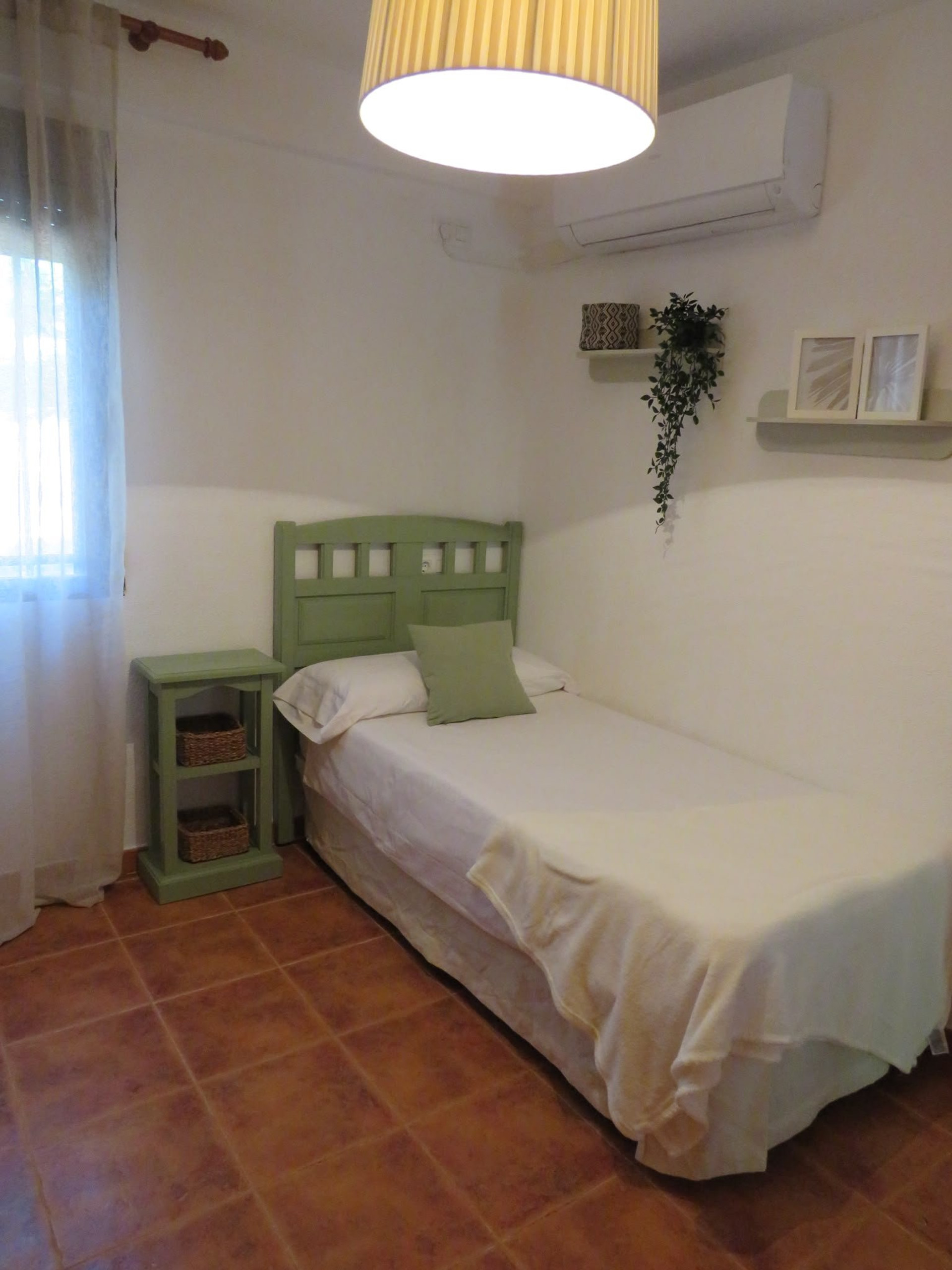 Single bedroom green headboard with shelves