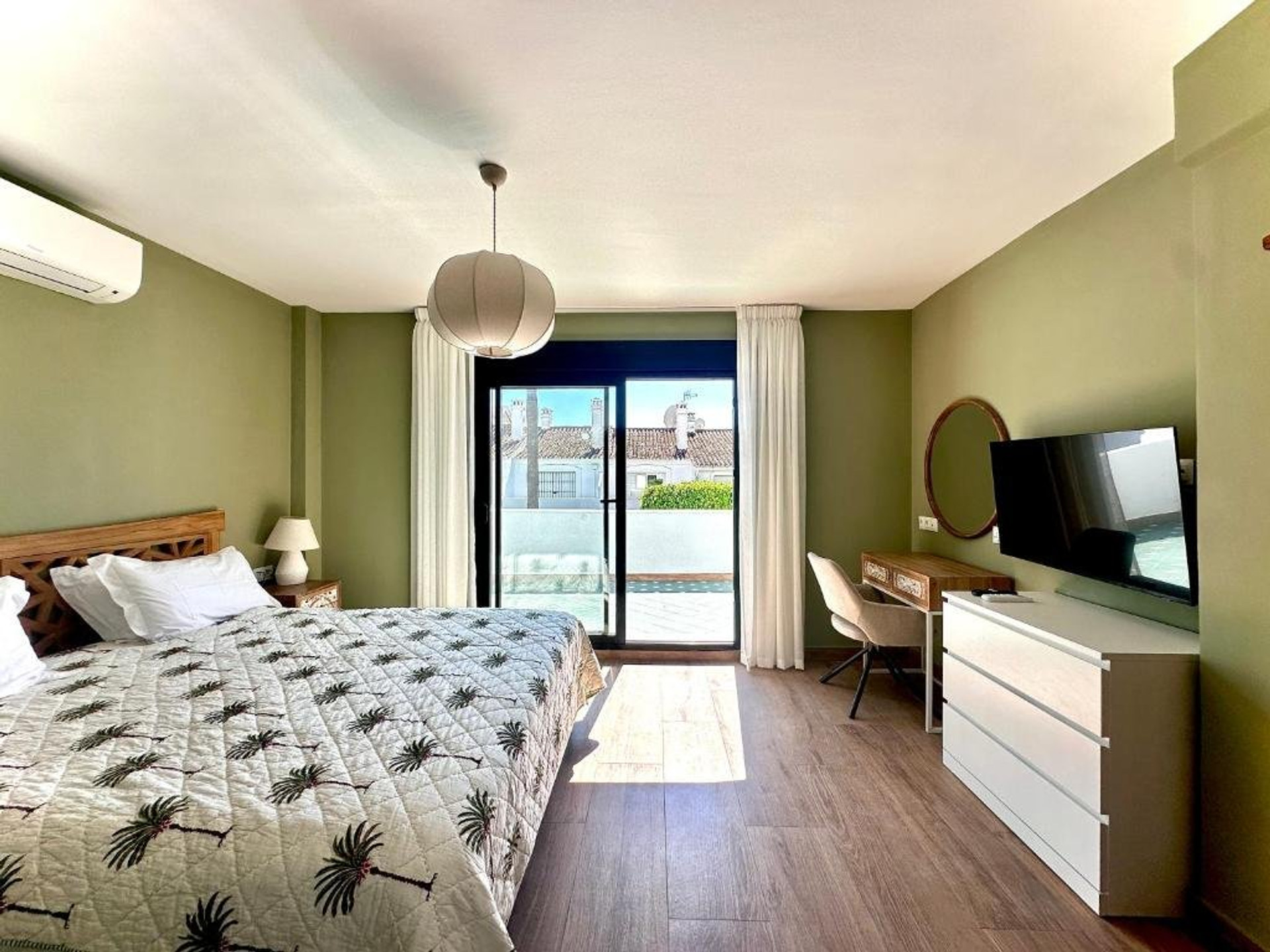 Bedroom with green walls, balcony access