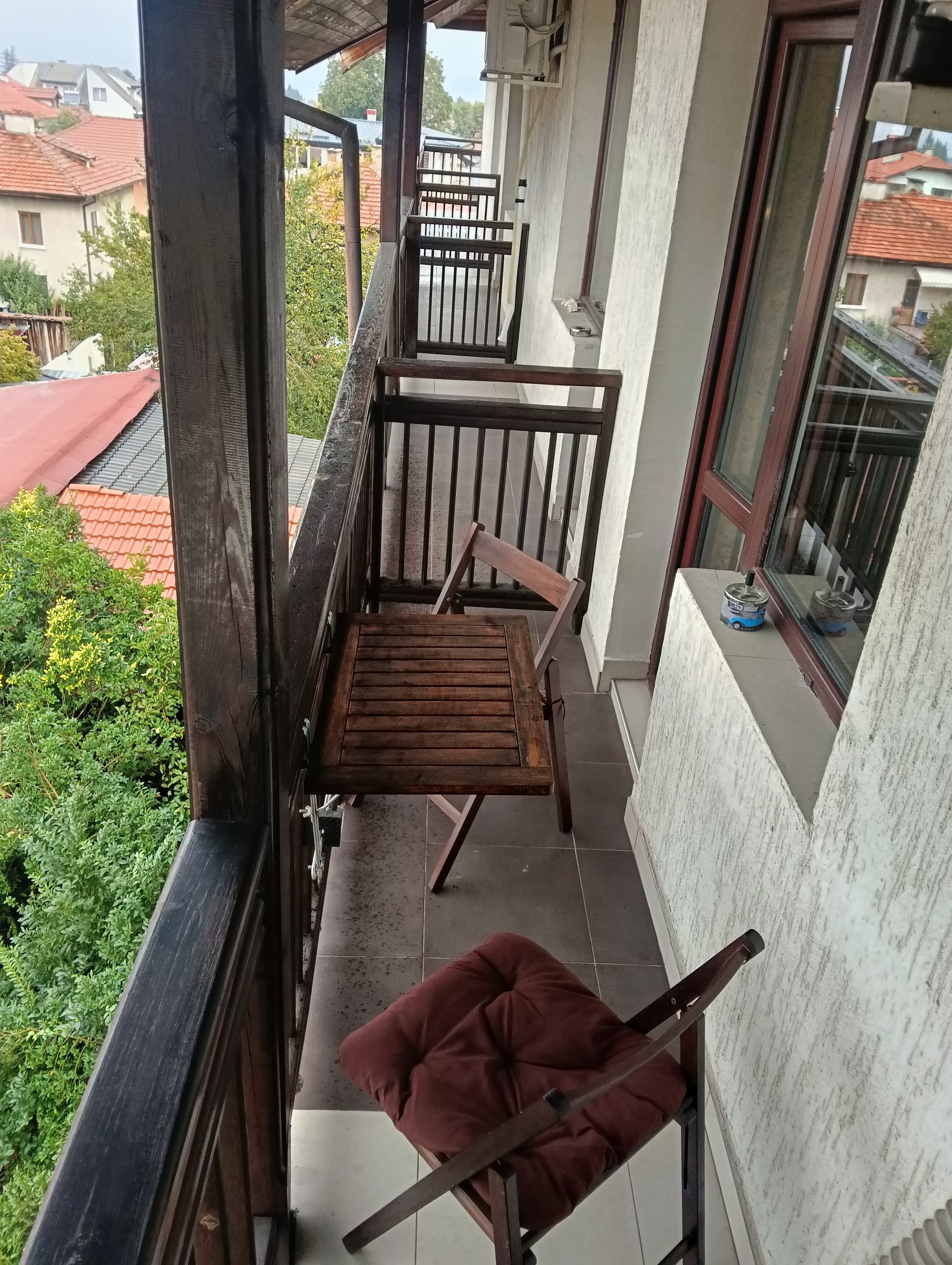 Balcony with folding table and chairs