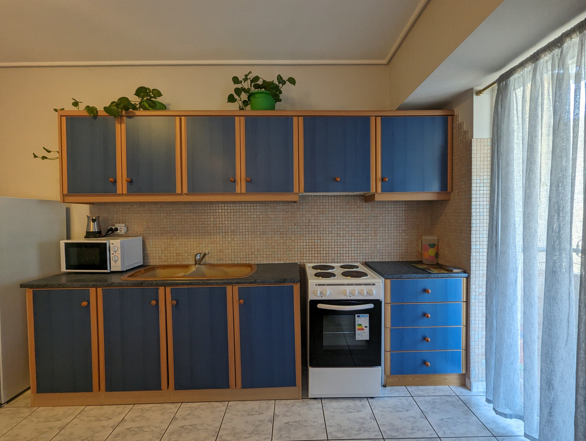 Kitchen with blue cabinets and stove