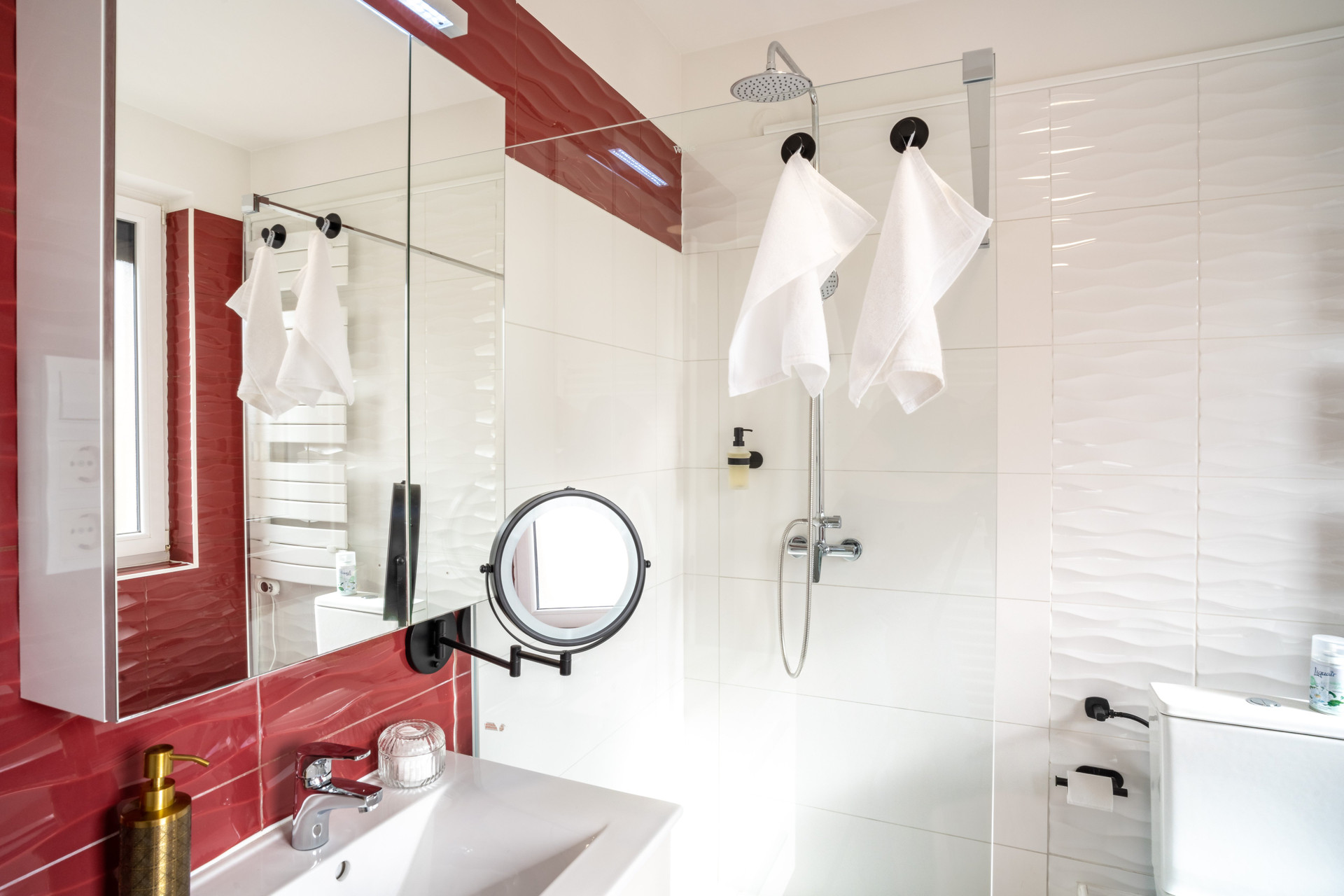 Spacious, modern bathroom featuring a large corner bathtub and a comfortable walk-in shower. Includes a vanity mirror for your daily convenience.