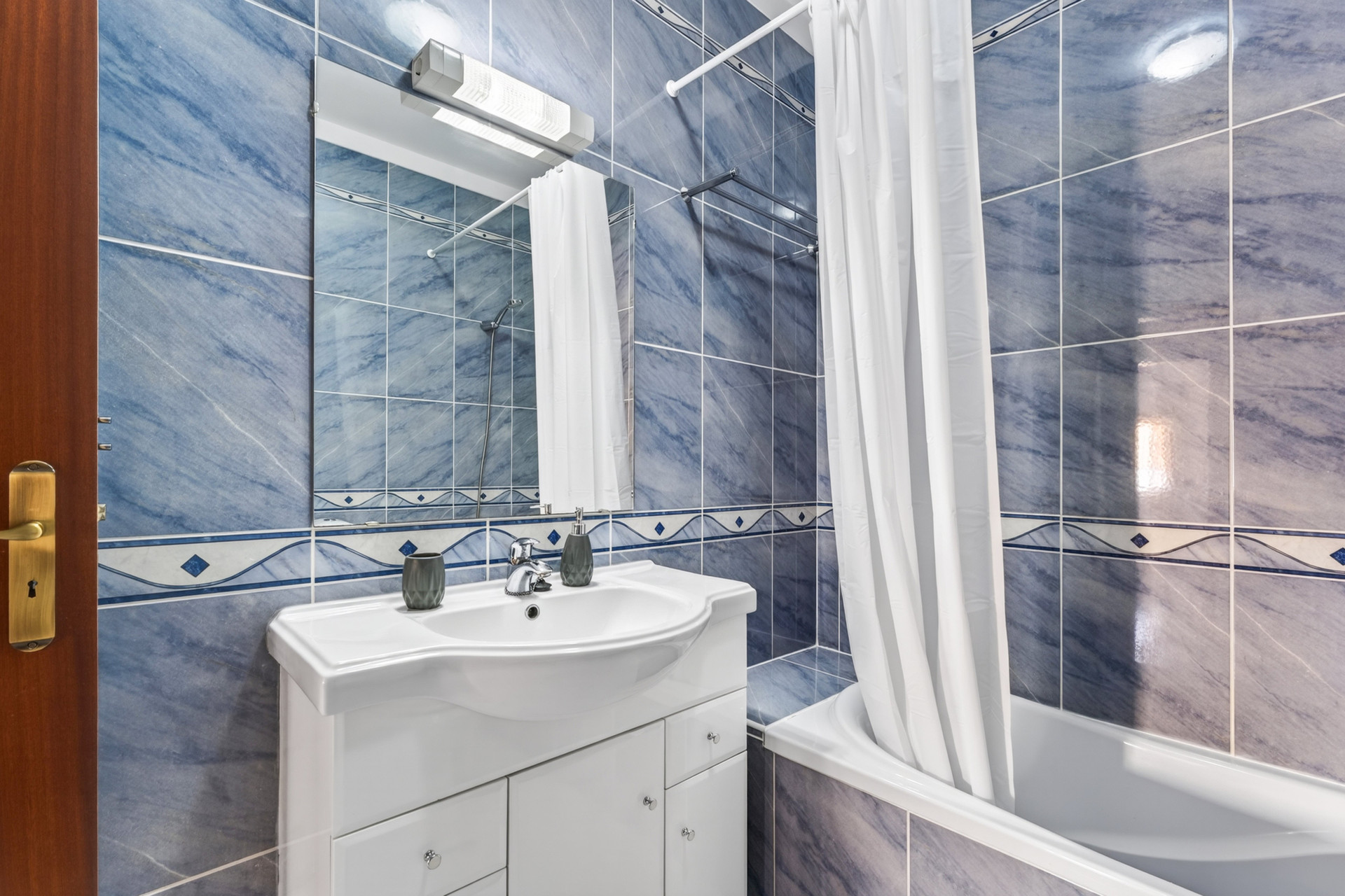 Blue bathroom sink and shower