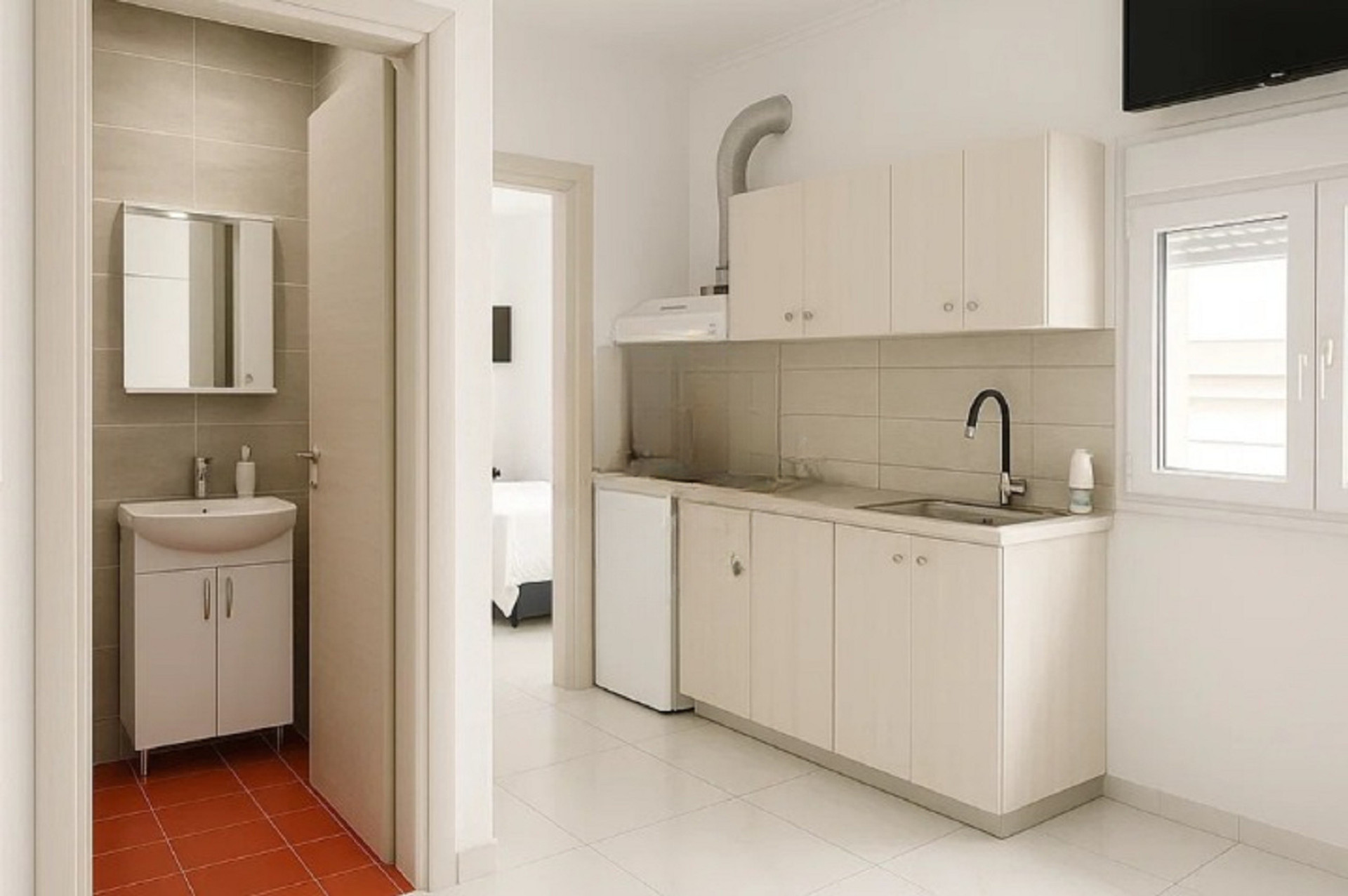 Compact cooking area with essential amenities, perfectly integrated into the apartment's layout