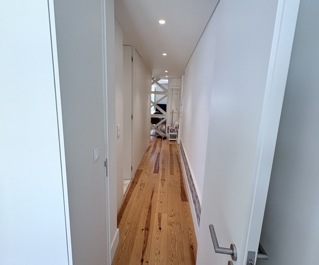 Long hallway with wood floor