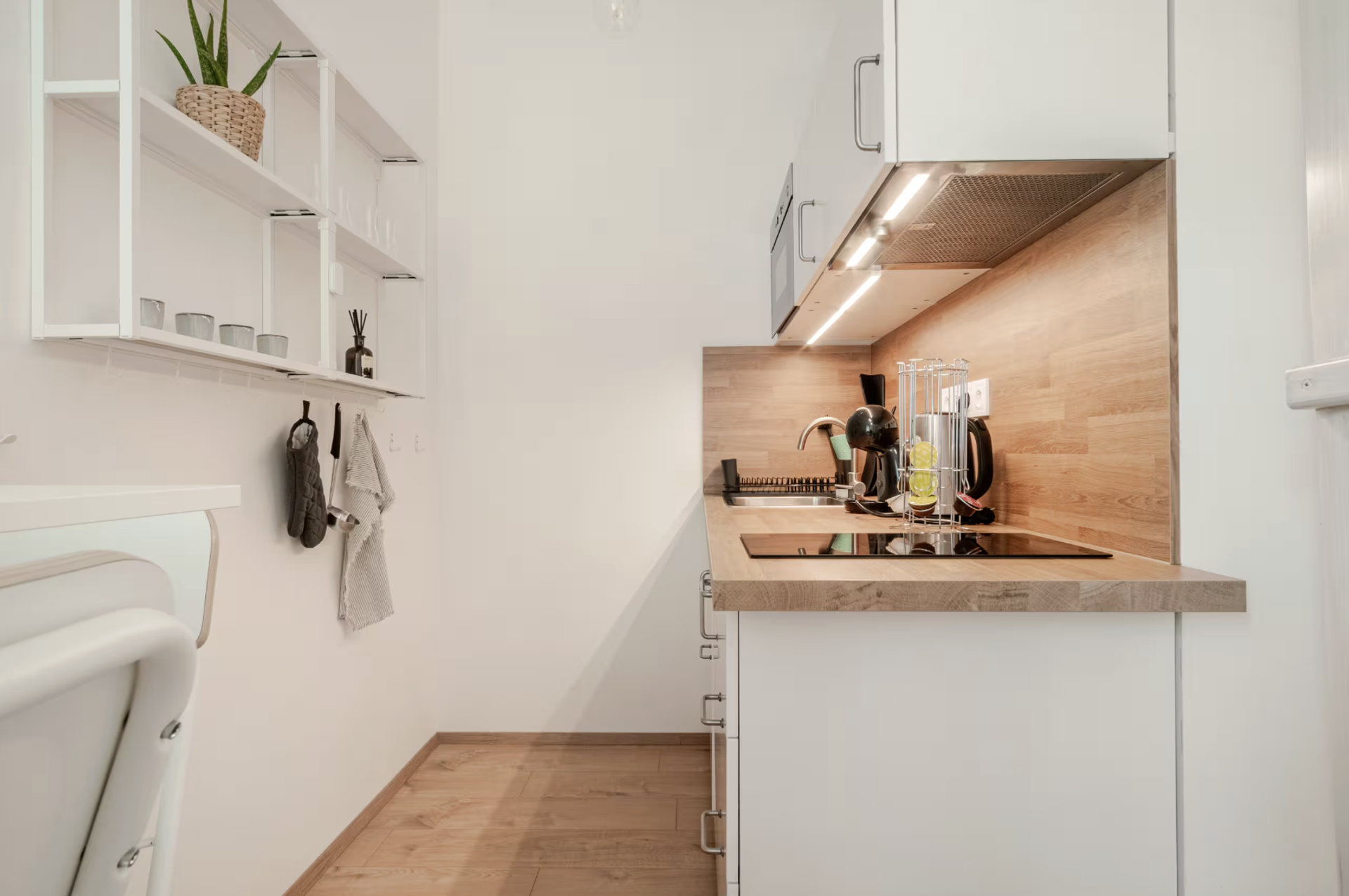 Compact kitchen with wood backsplash