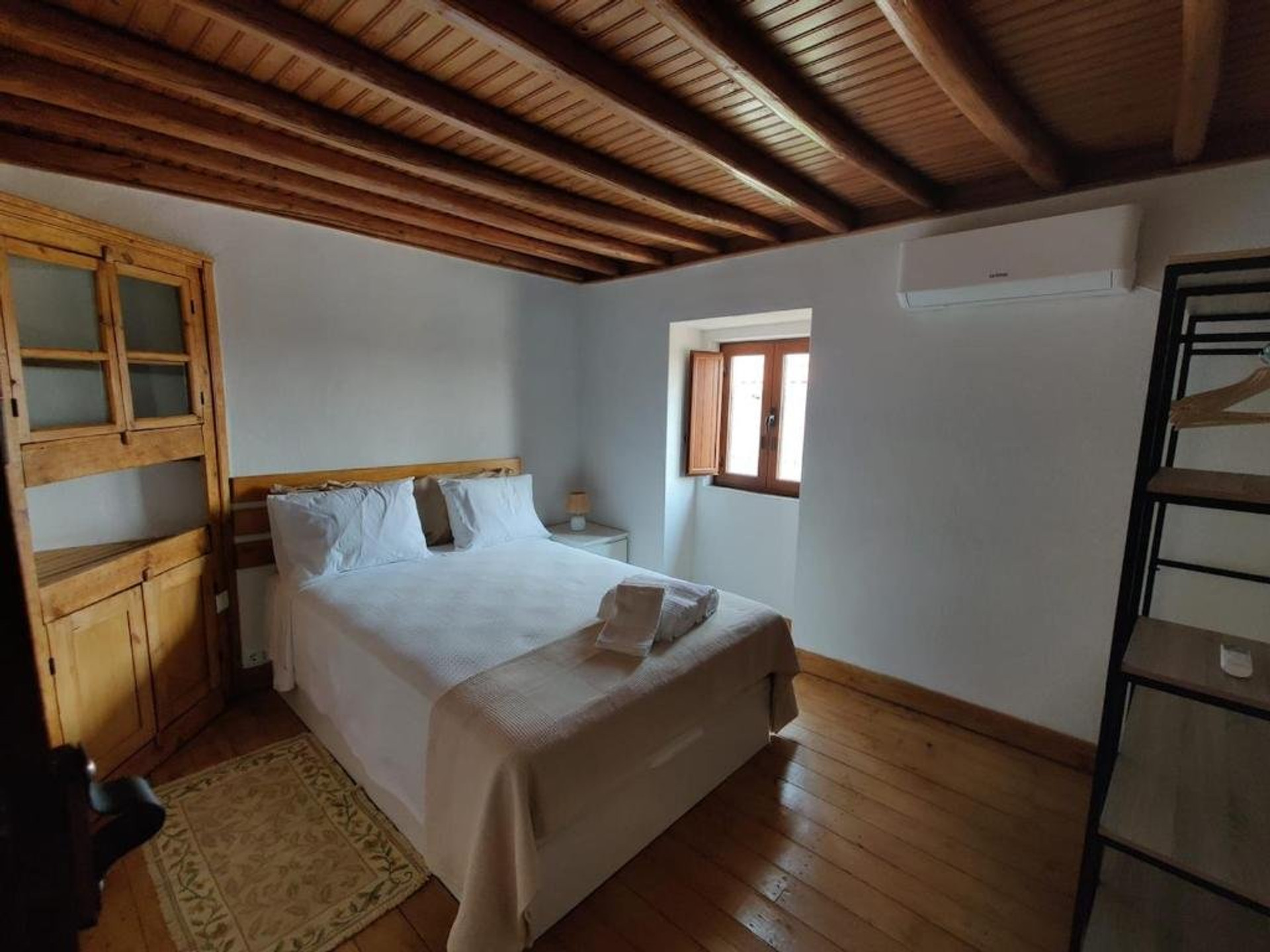 Cozy bedroom with wood beams