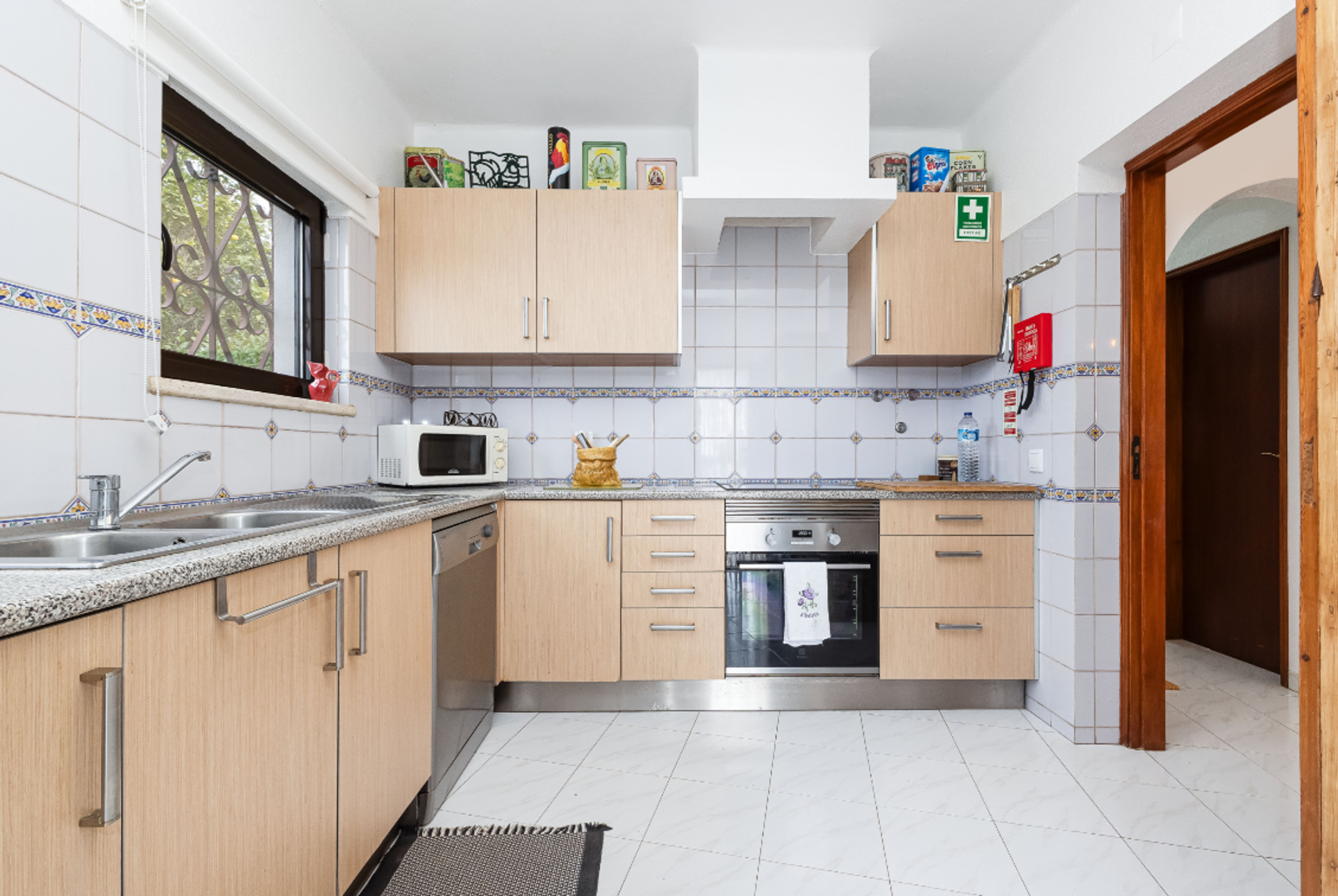 Kitchen with oven and tiled walls