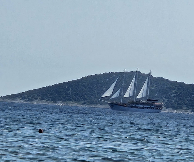 Sailboat cruising near island