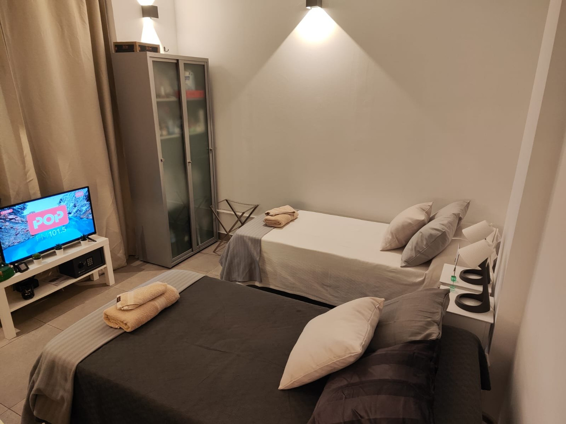 Bedroom with beds and TV