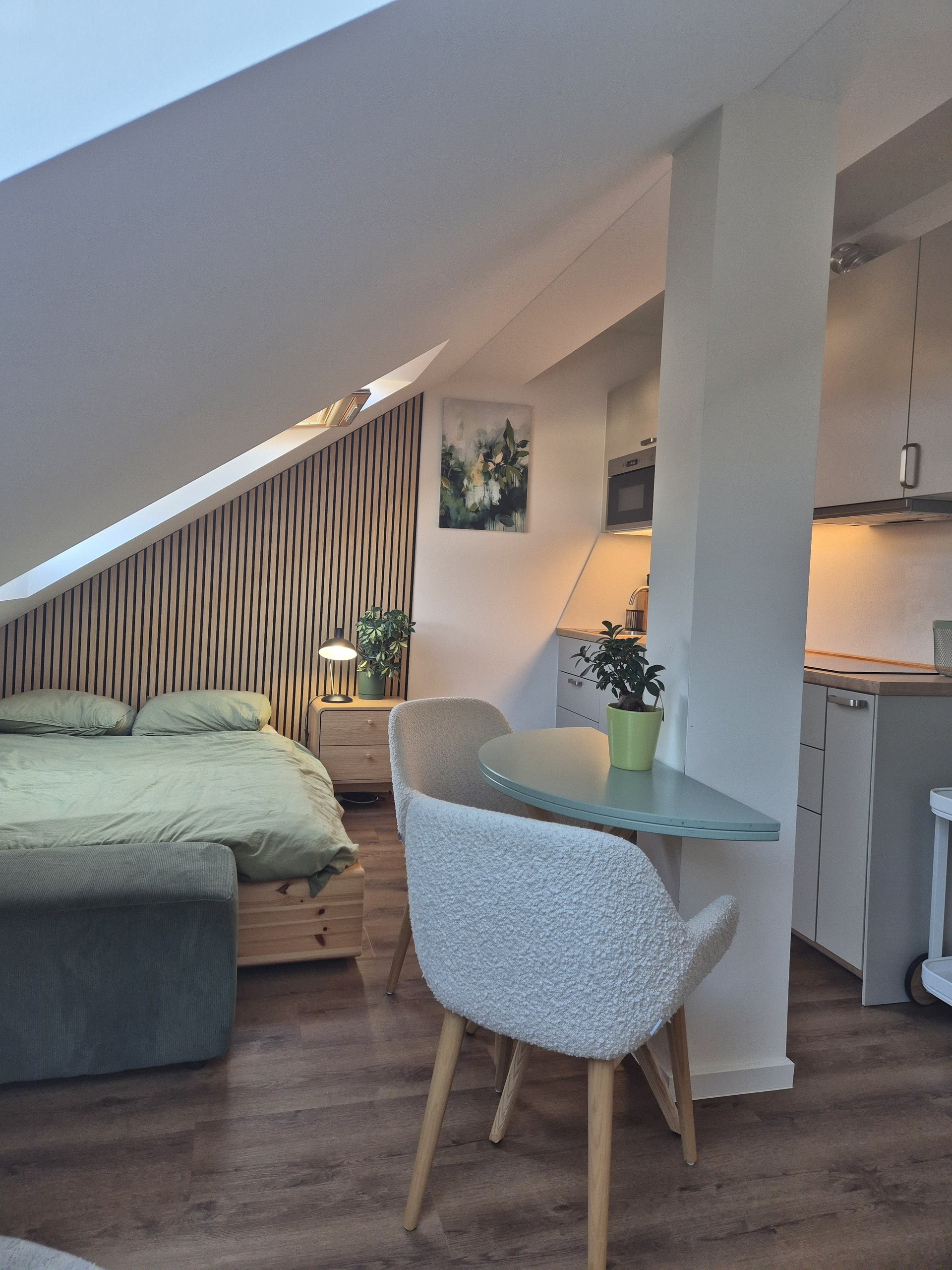 Bed, dining table, and kitchenette