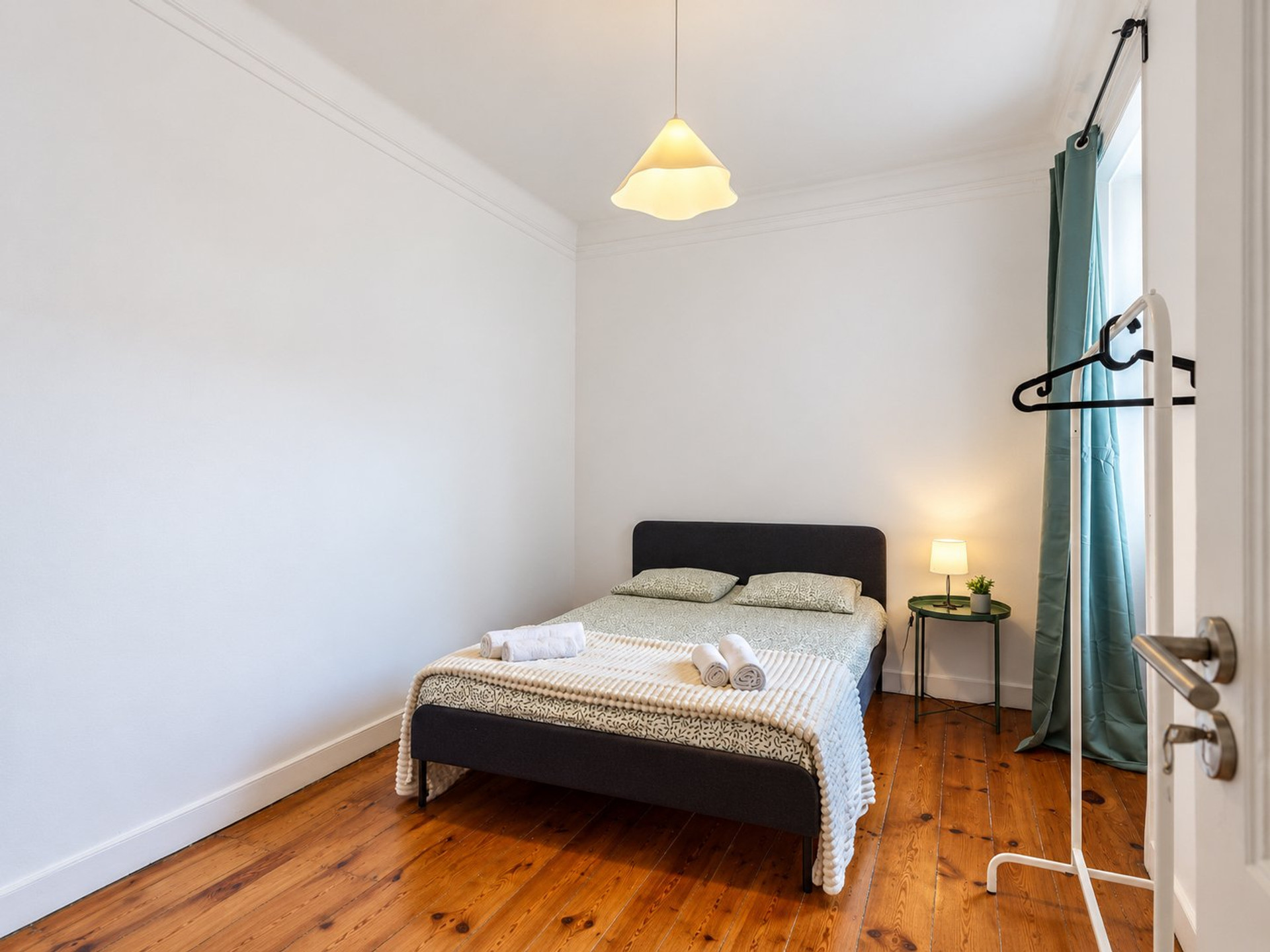 Bedroom with wooden floors and double bed