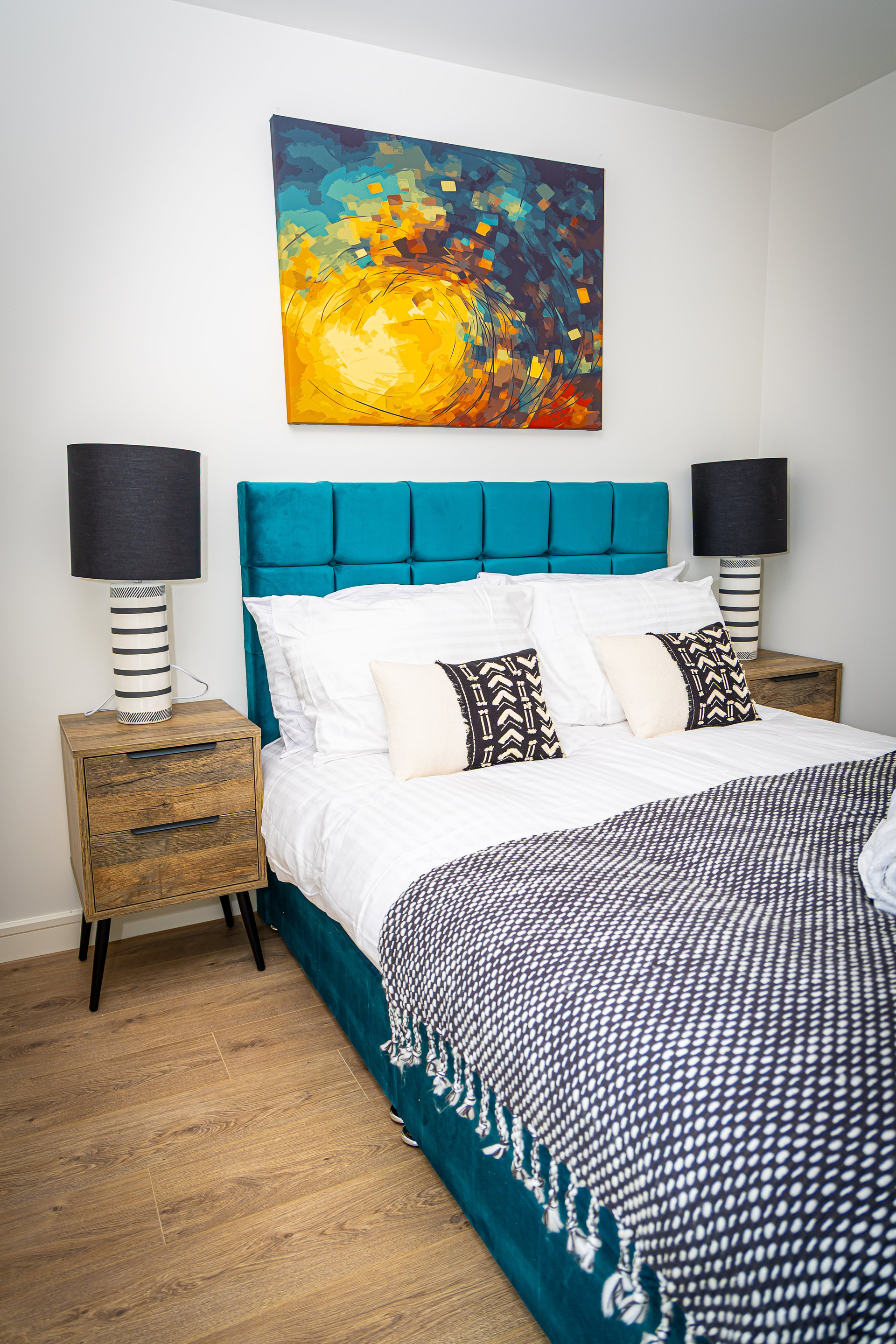 Teal double bed with artwork