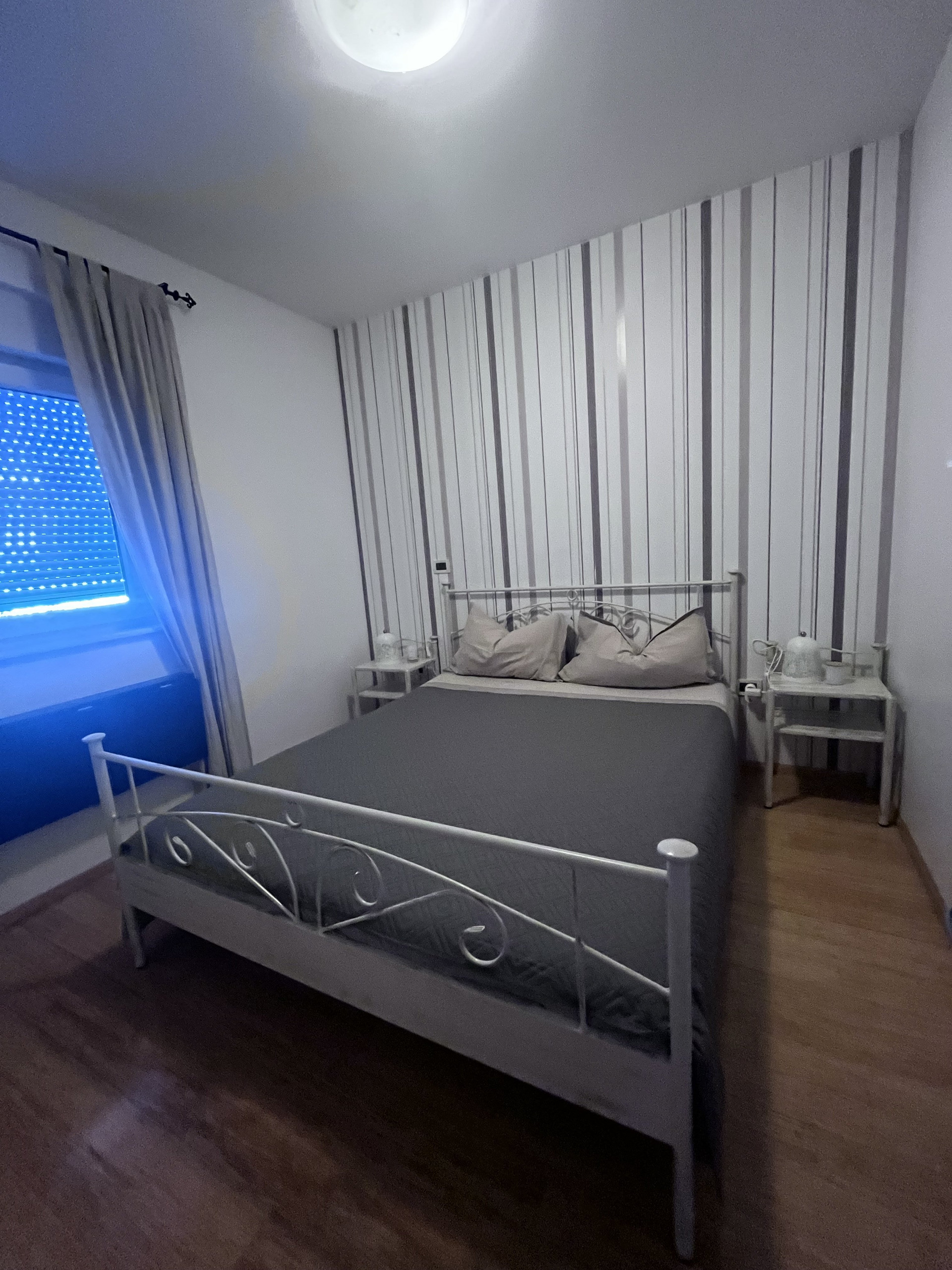 Bedroom with grey bed and nightstands