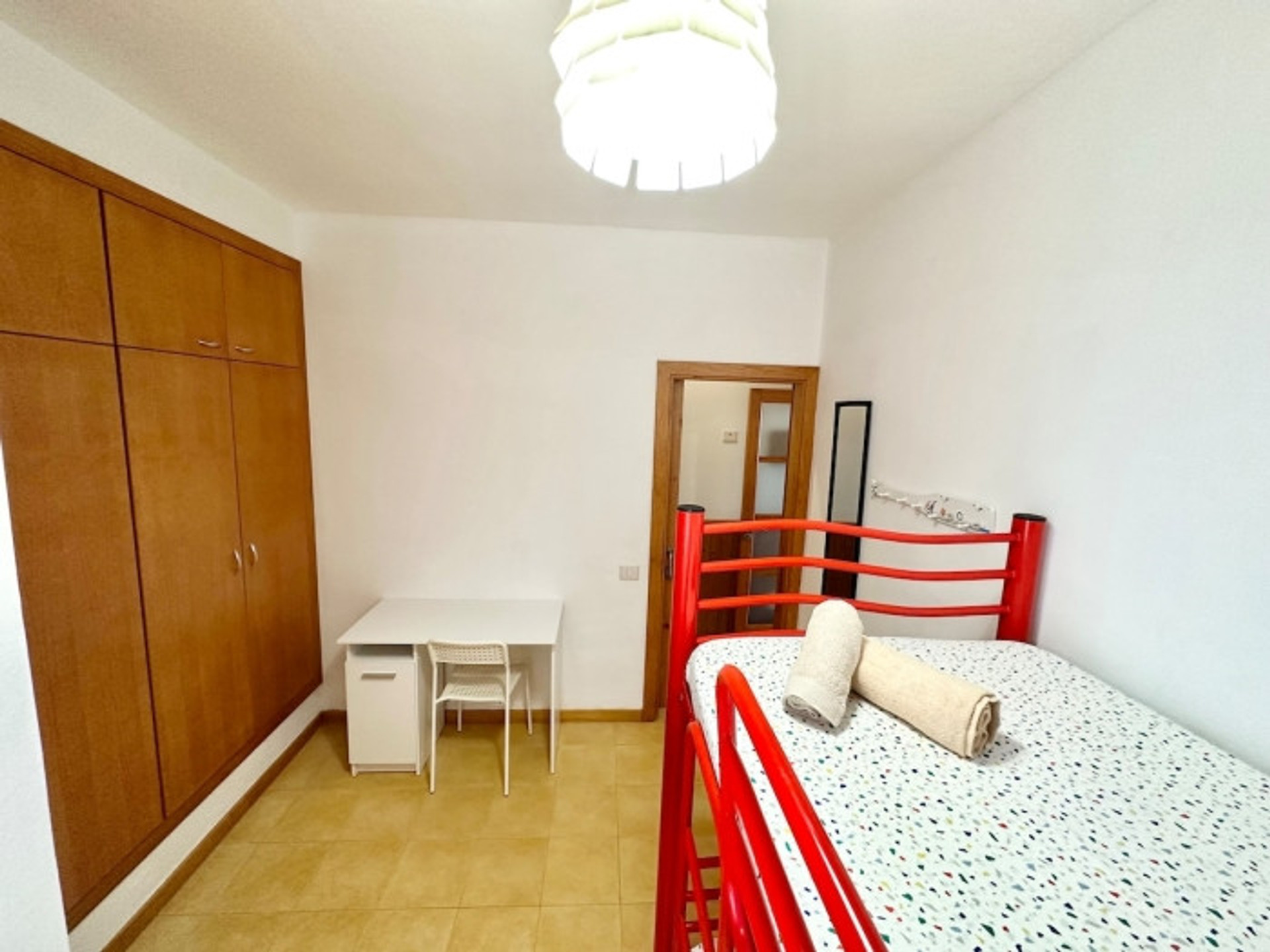 Single bedroom with red bed