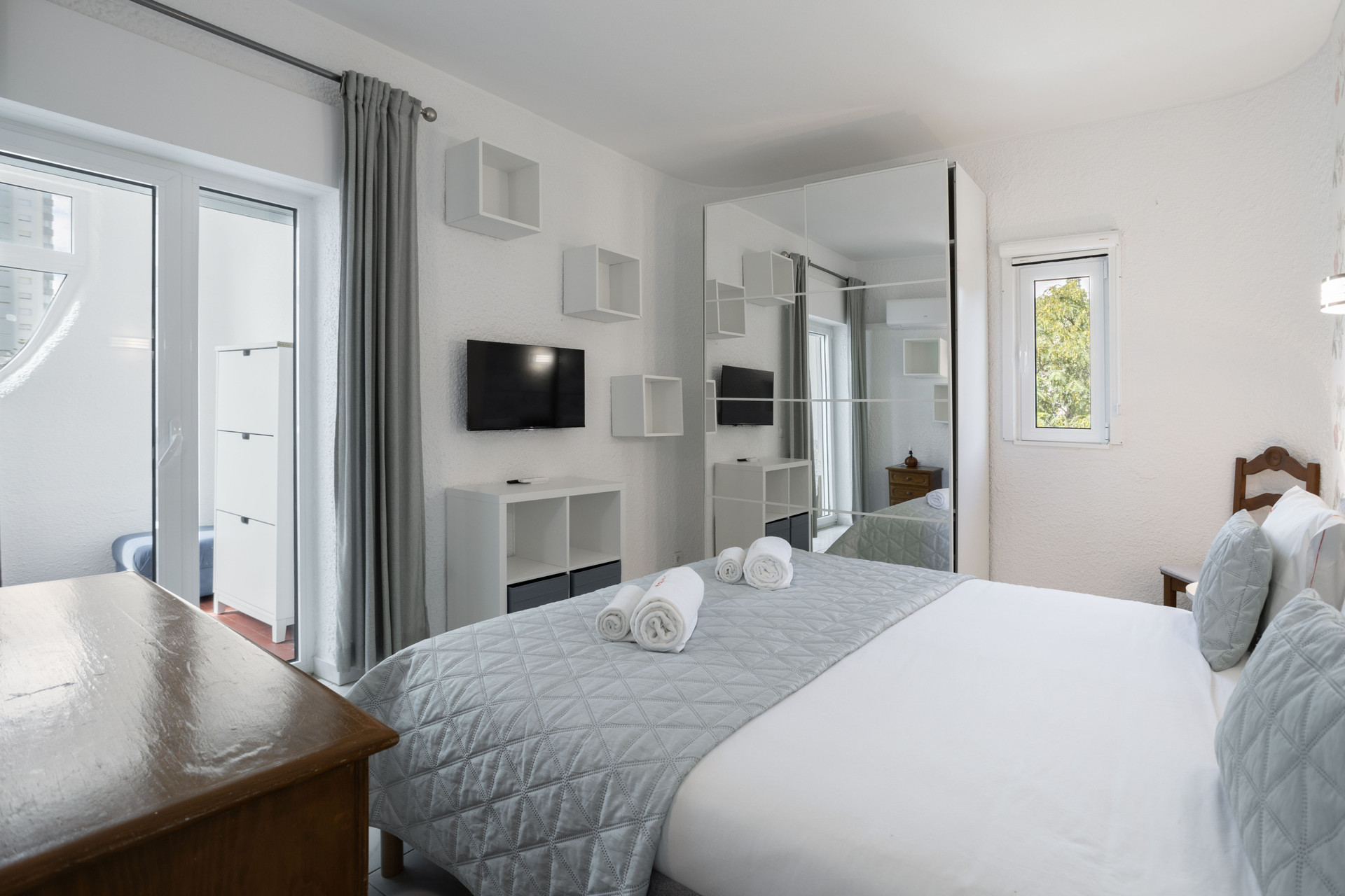 Master bedroom with TV and balcony