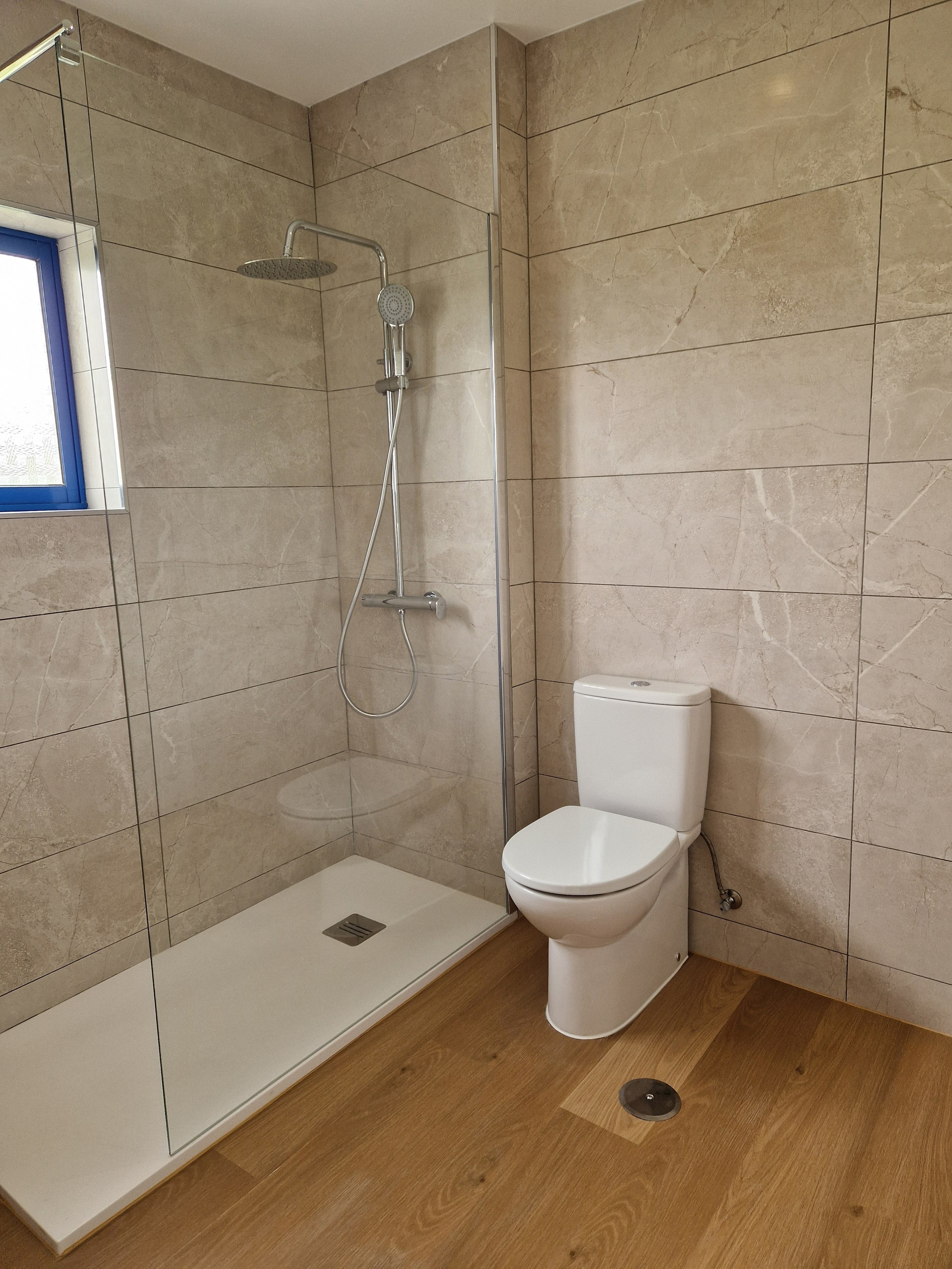 Bathroom with glass shower, toilet