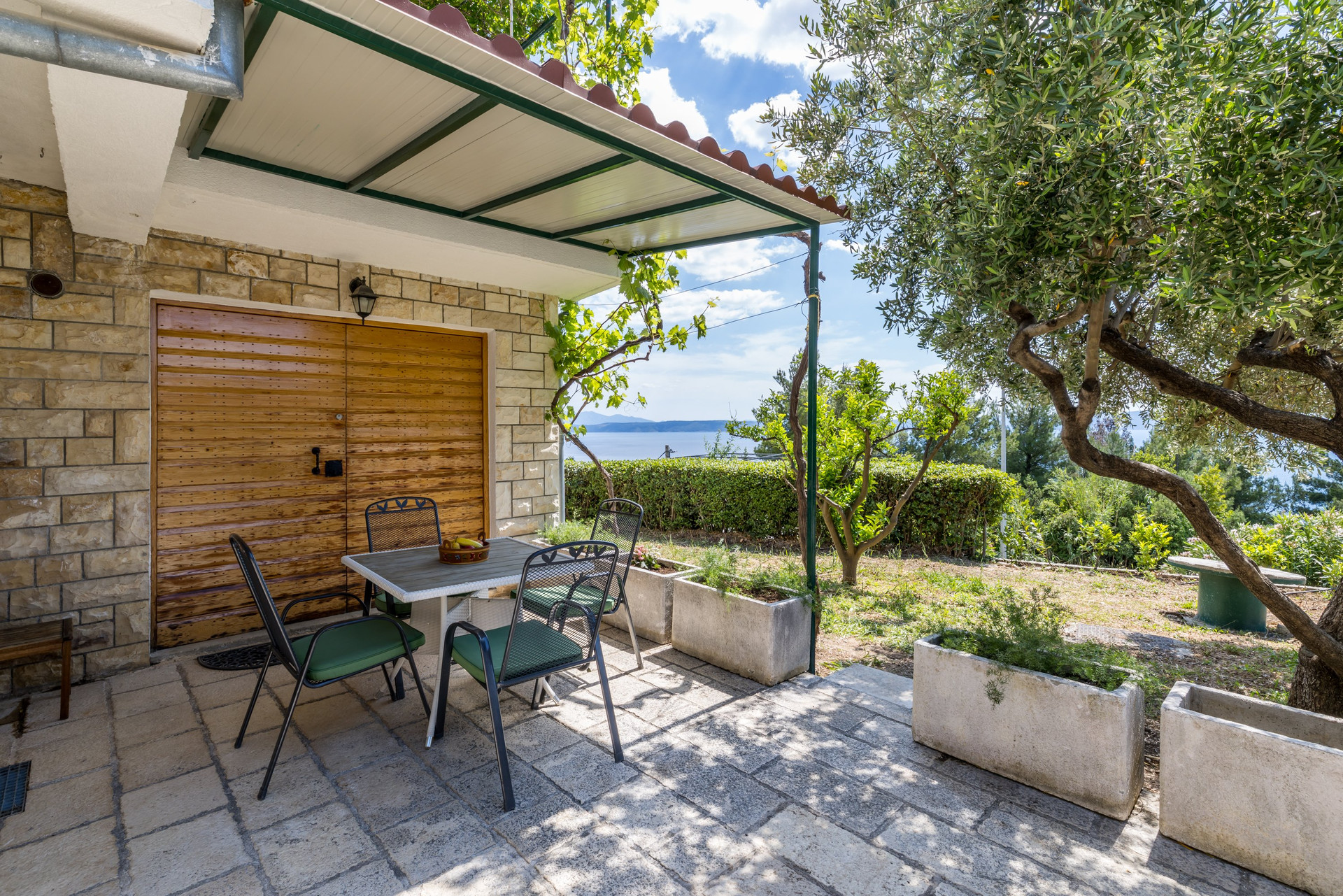 Patio with a table and chairs, perfect for outdoor dining and relaxing.